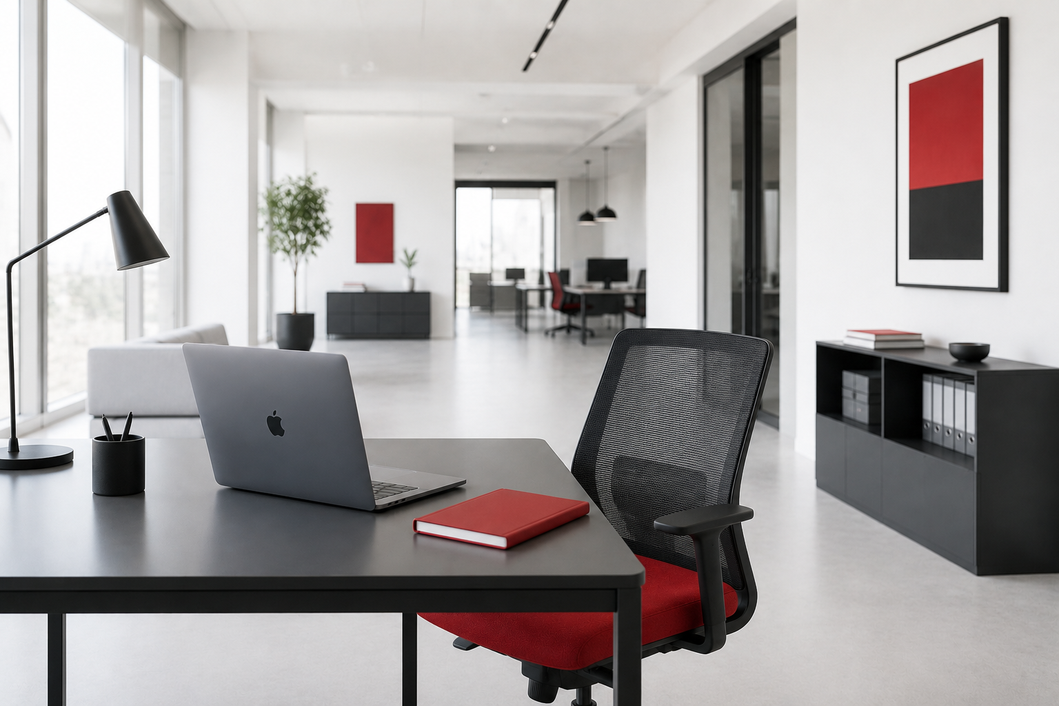 A sleek black desk with a MacBook