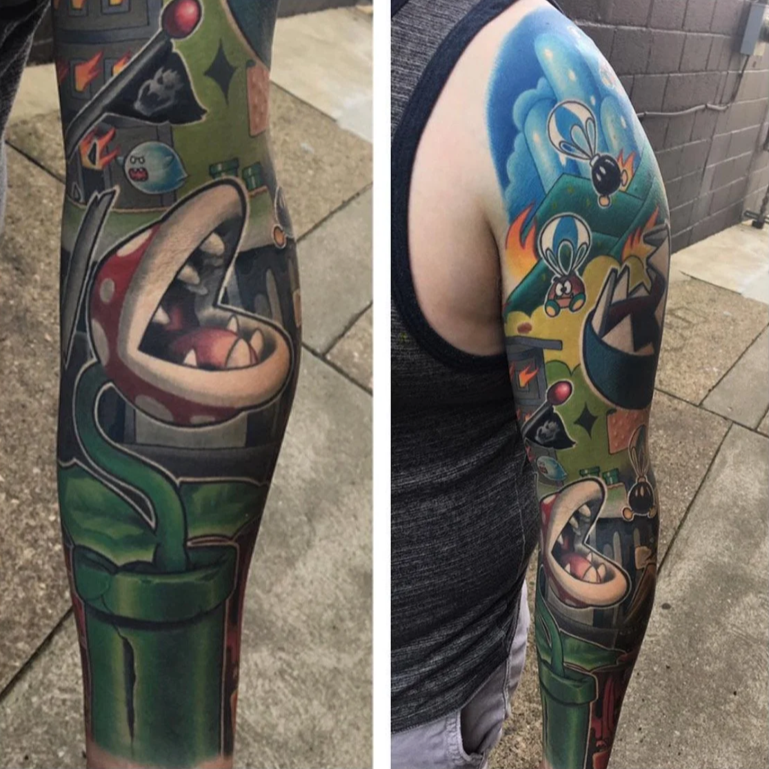 Award-winning tattoo sleeve featuring characters from the Super Mario video game series, including a green pipe, a bouncing green Koopa shell, a Bob-omb, and a Piranha Plant by Jesse Smith at Human Production Gallery in Bethel Park, PA.