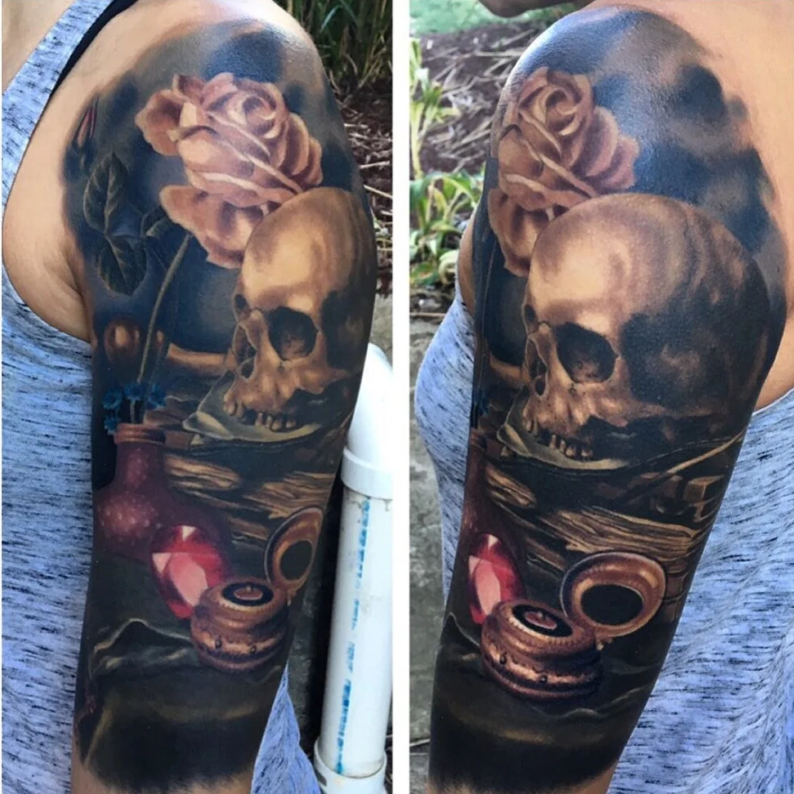 Tattoo of a human skull and roses by Jesse Smith in Bethel Park, PA.