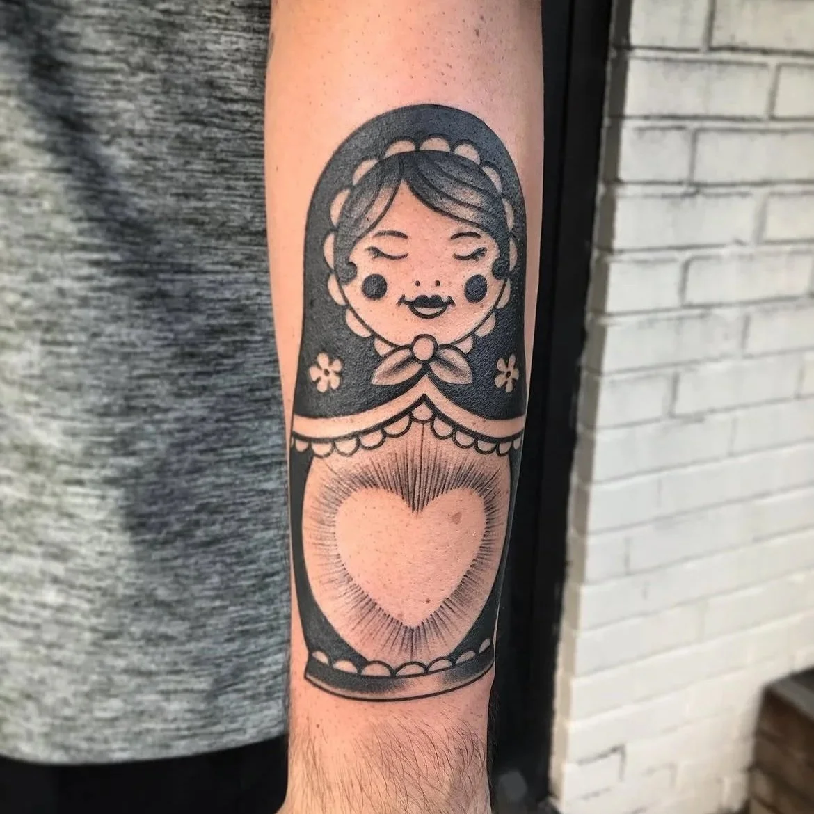Black and gray arm tattoo of nesting doll by Jesse Smith tattoo artist in Pittsburgh, PA