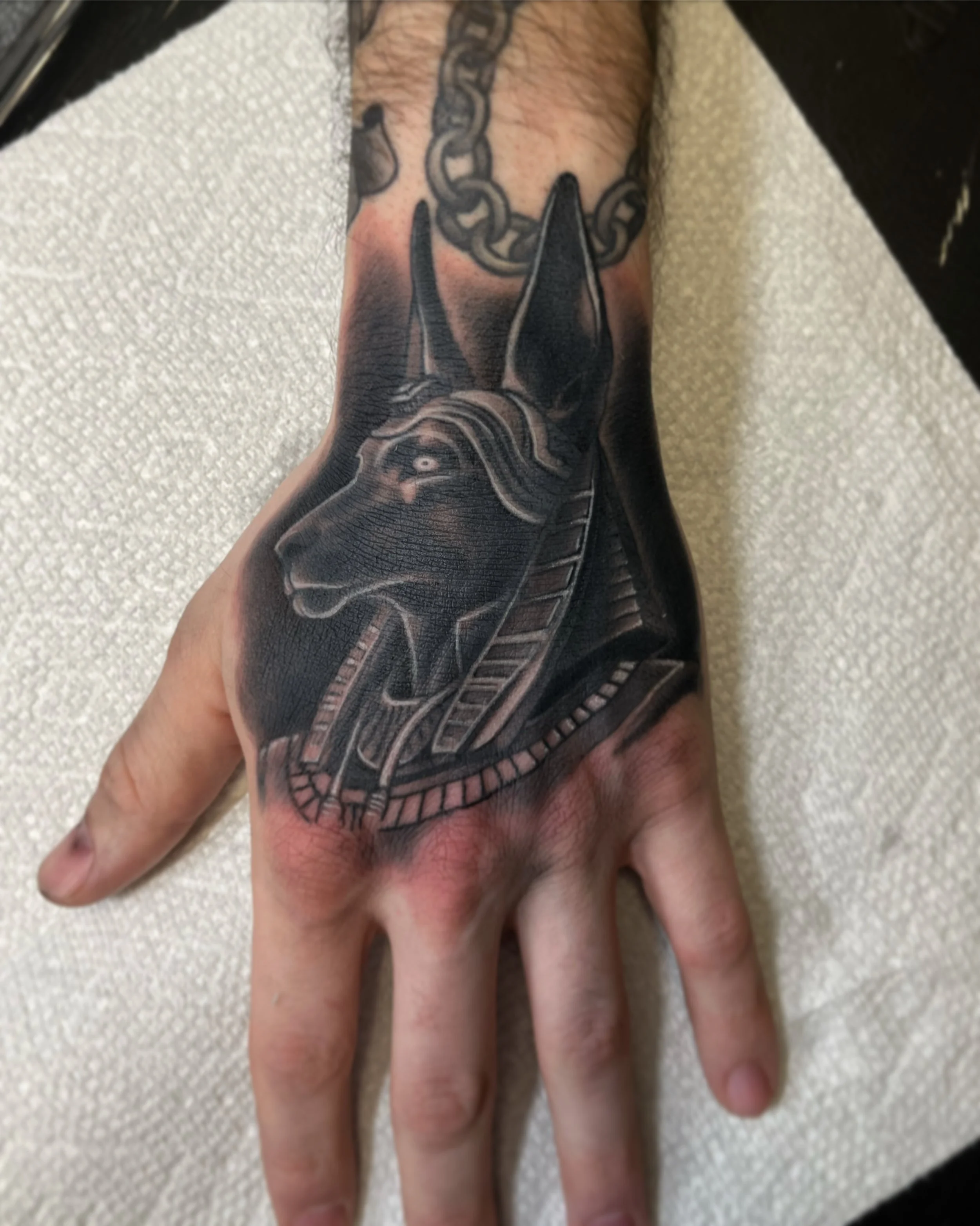 Close-up of a person's hand with a detailed black and gray tattoo by Jesse Smith serving Pittsburgh, PA.