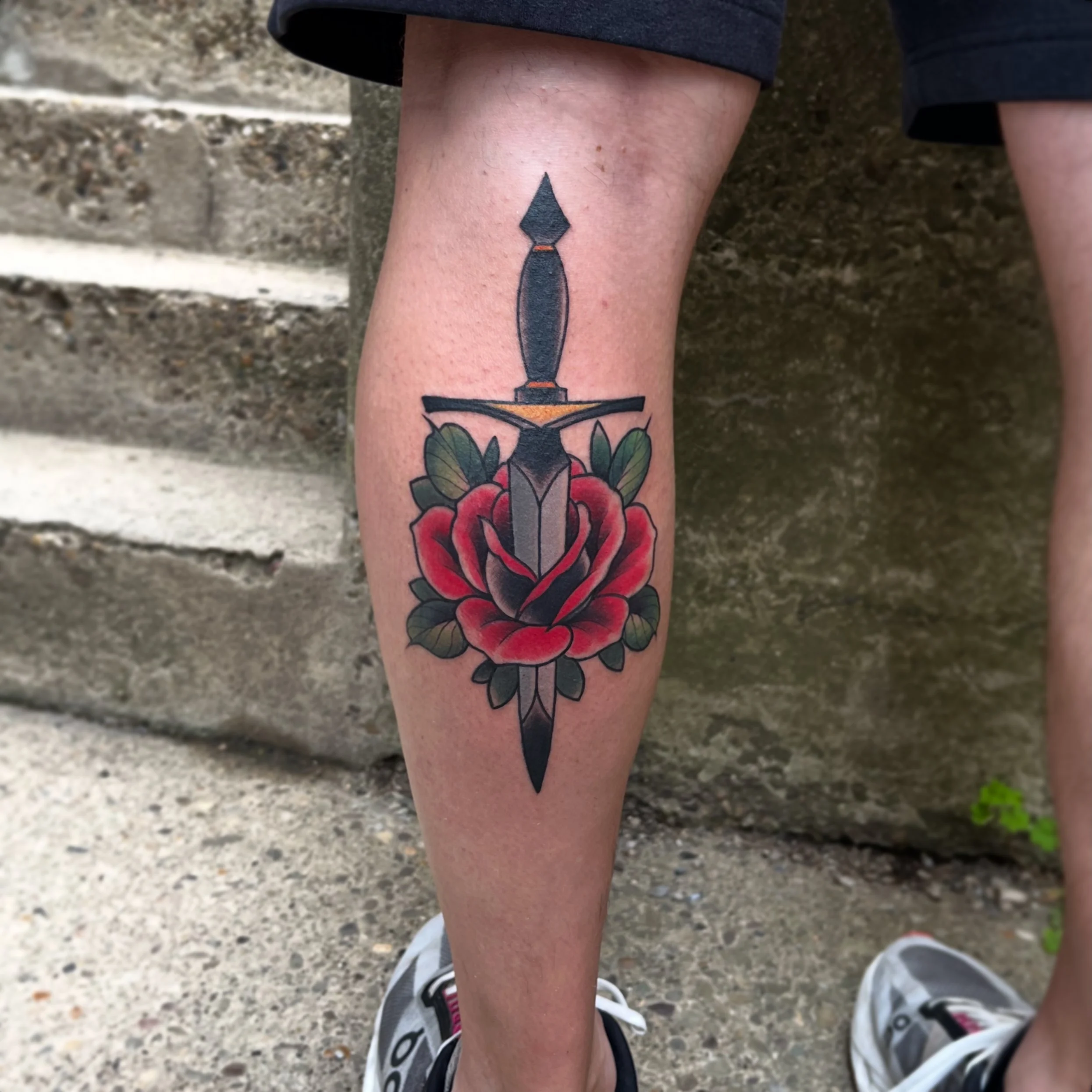 Traditional tattoo of a dagger and a rose by Jesse Smith tattoo artist serving the South Hills of Pittsburgh.