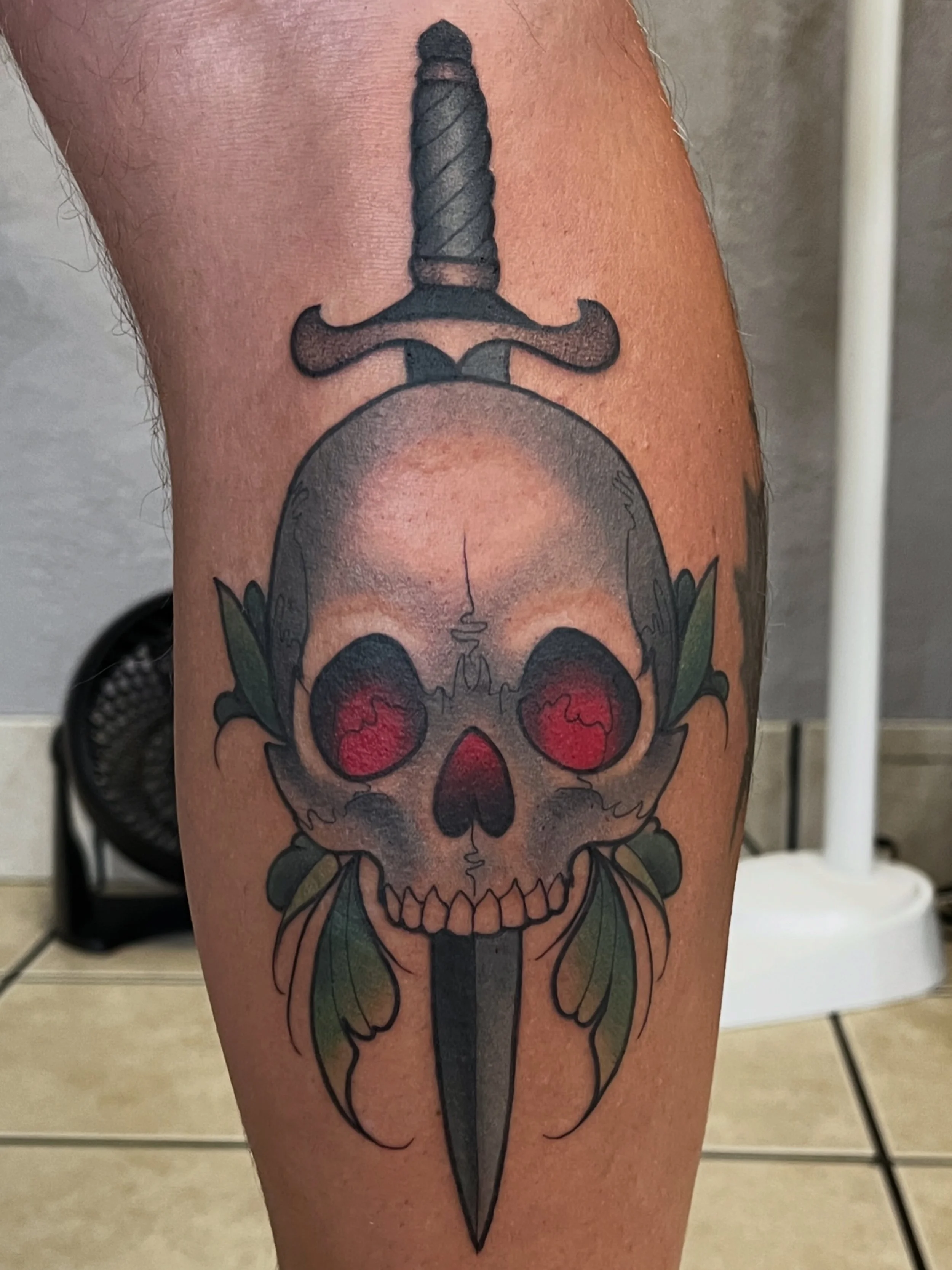 Skull and dagger tattoo on leg by Jesse Smith, Tattoo Artist in Bethel Park, PA