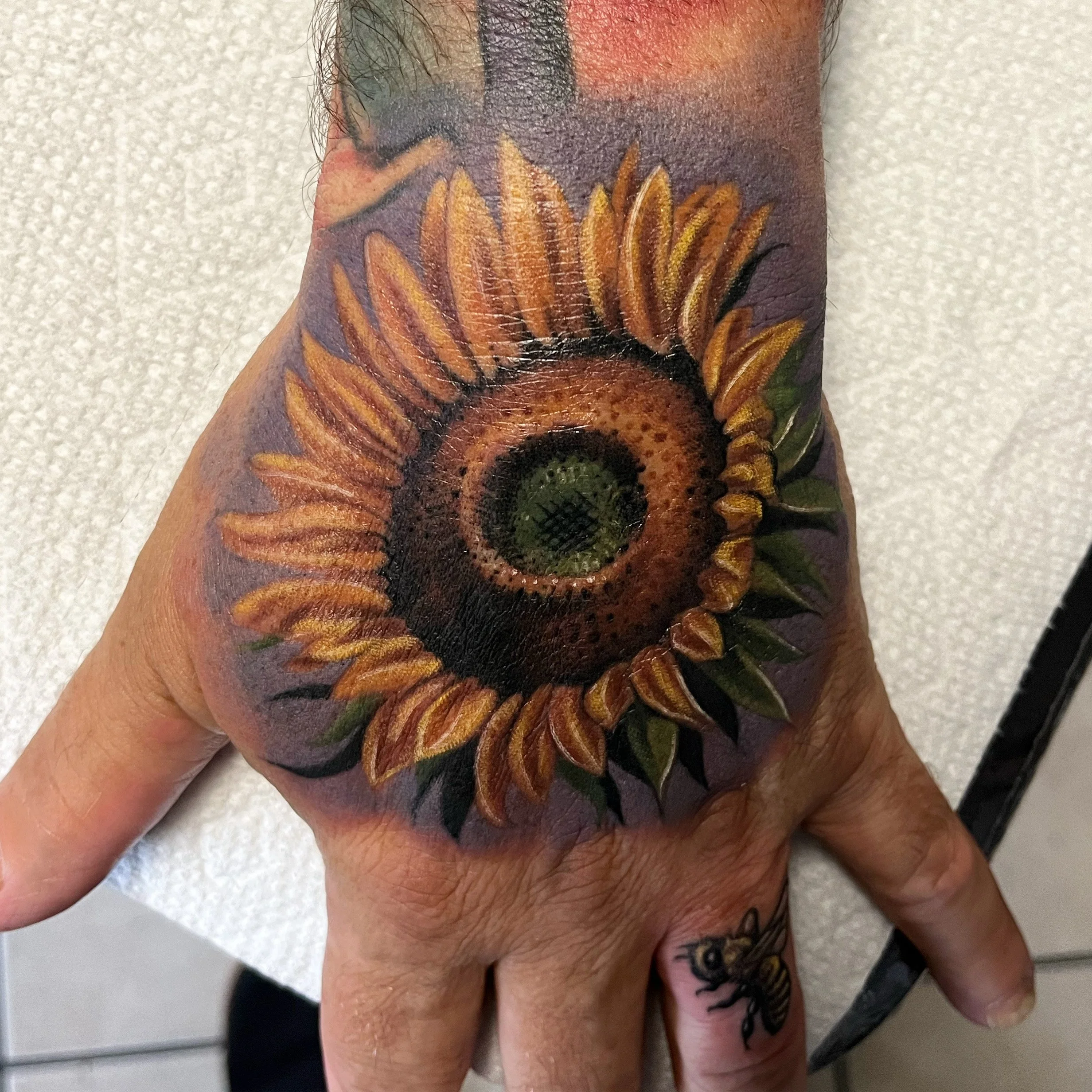Sunflower hand tattoo by Jesse Smith at Human Production Gallery in Bethel Park, PA.