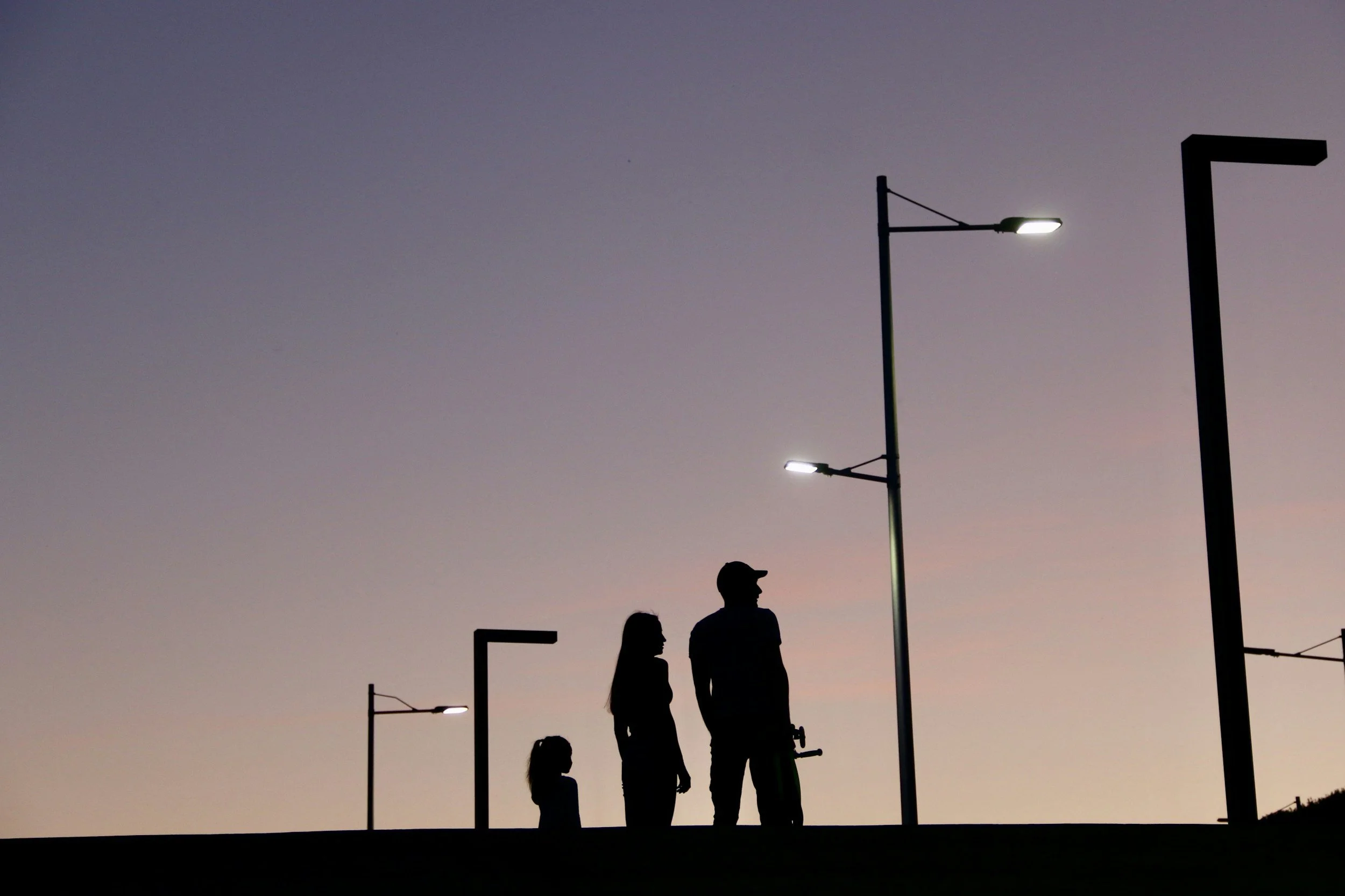 Silhouette of a family standing together at dusk, representing long-term retirement and longevity planning