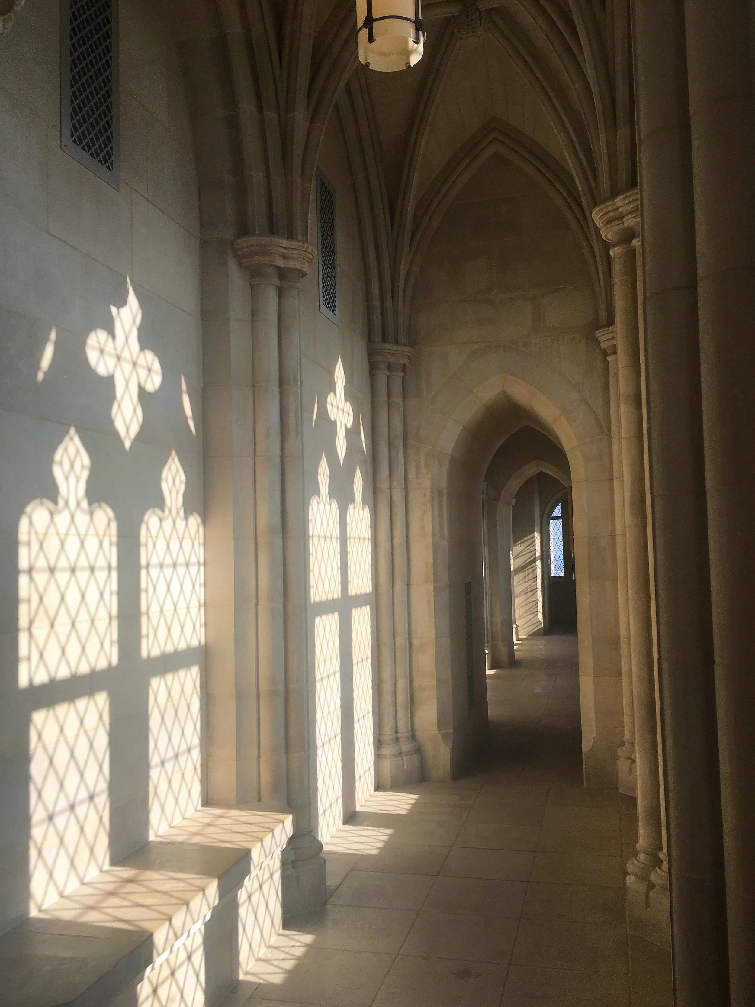 Sunlight casting patterned shadows on the interior walls of Washington National Cathedral