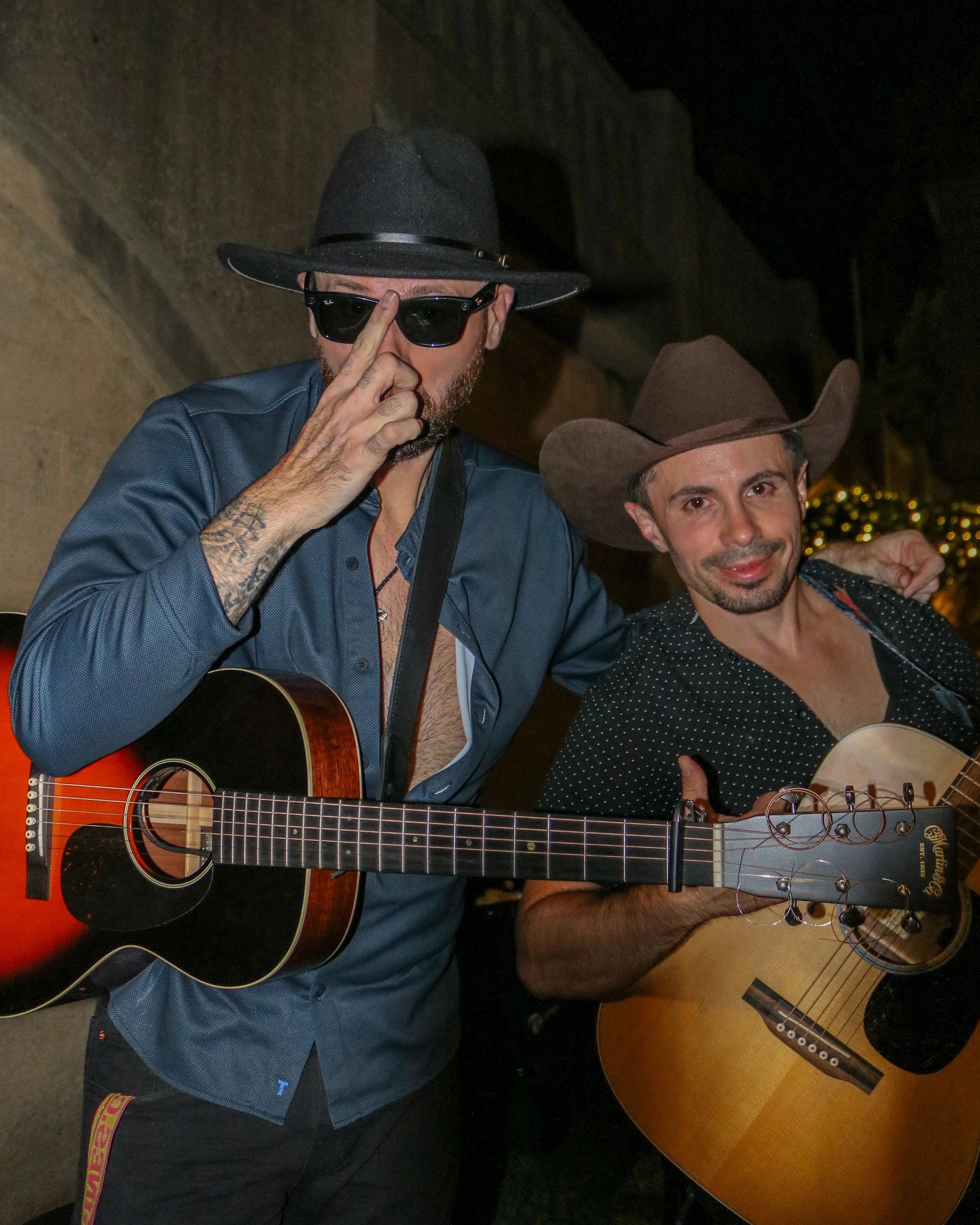 Corey James and Kevin Andrews pose for the camera while holding their guitars