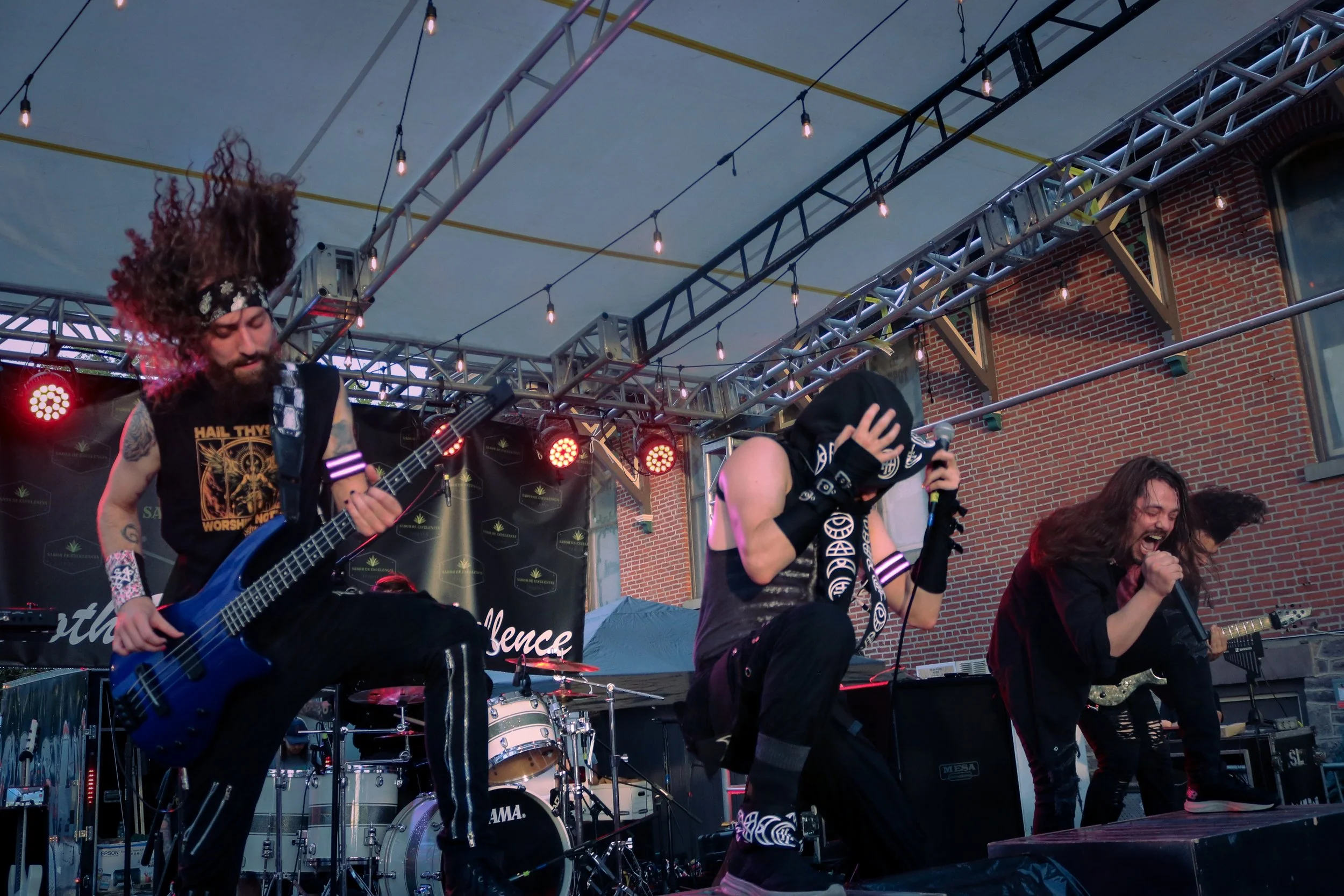 Kvrma performs live on stage, with band members playing instruments and singing