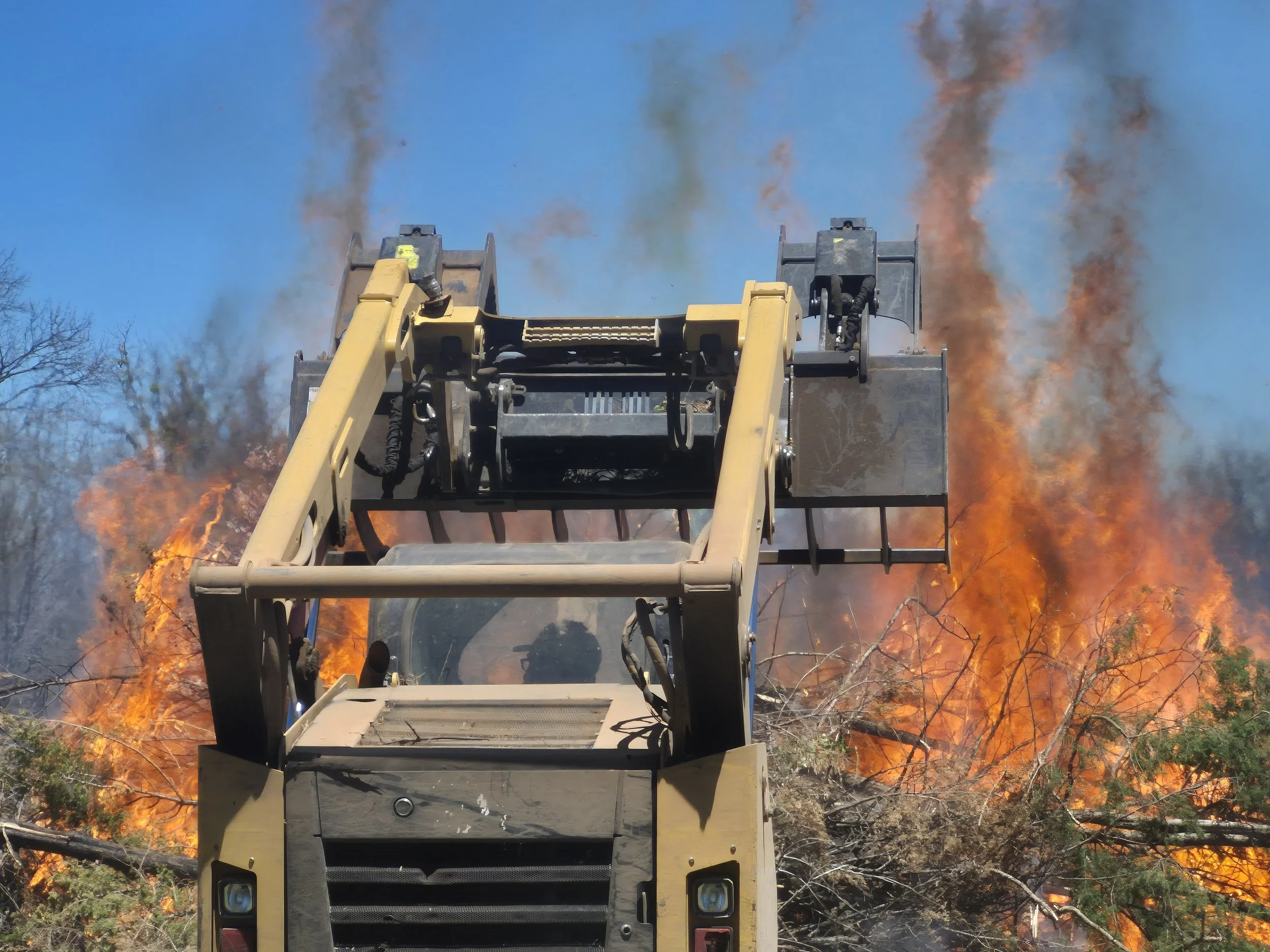 Our 299D dropping off a load to our designated burn site