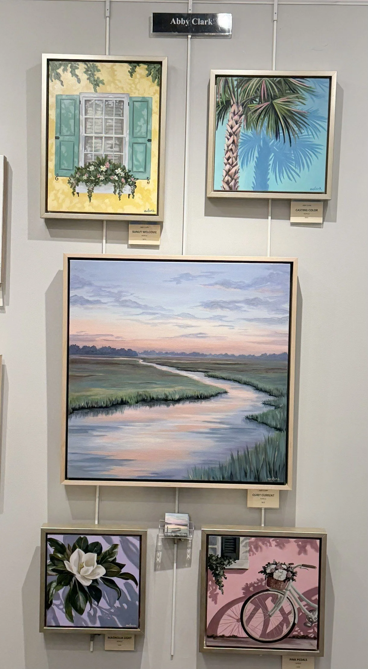 Abby Clark’s gallery wall at the Charleston Artist Guild Gallery, with Lowcountry landscapes and Charleston-inspired paintings