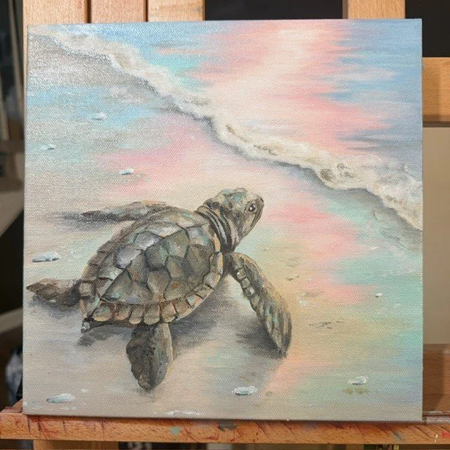 Sea turtle painting at the water’s edge by Abby Clark