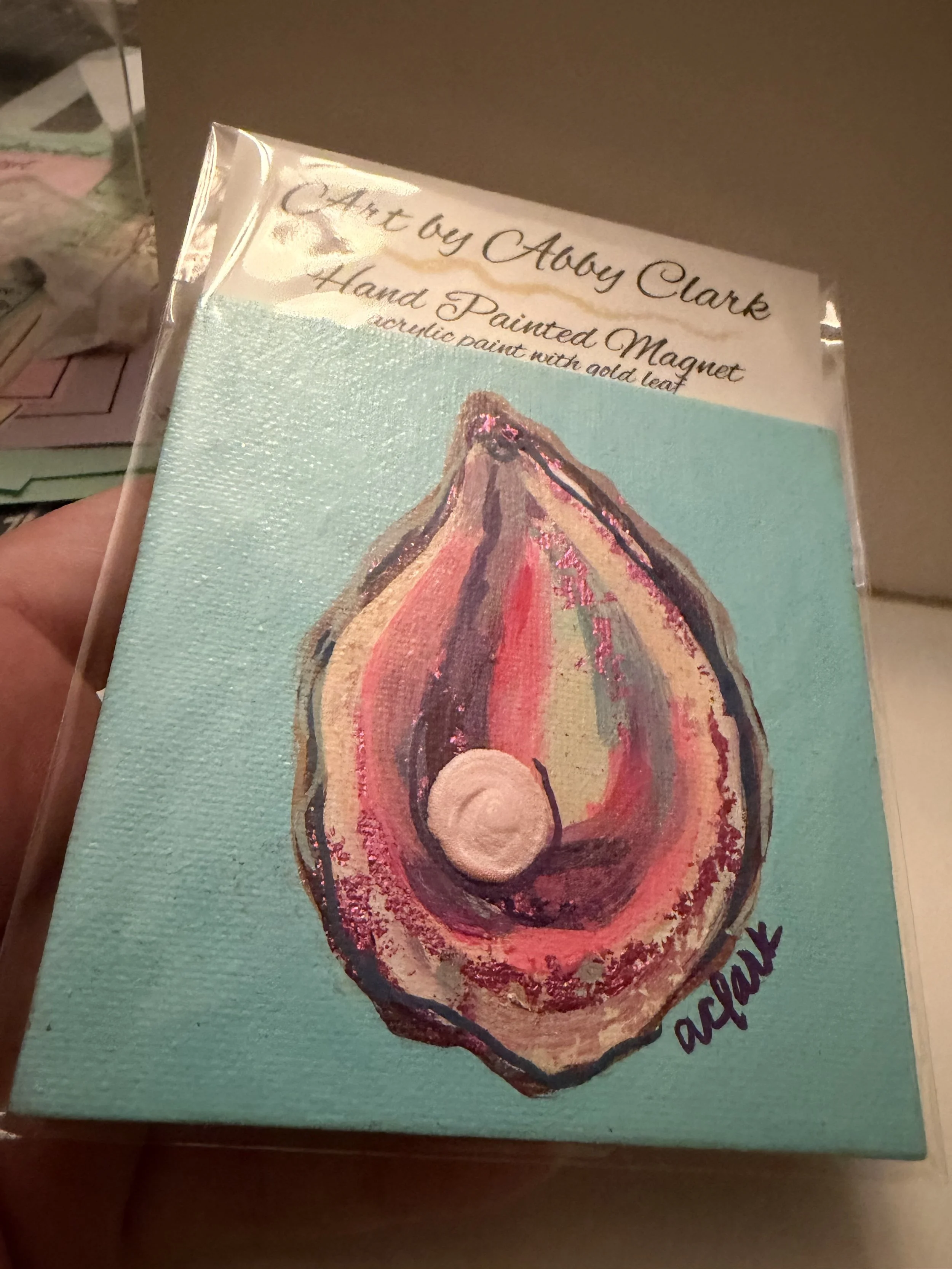Oyster mini canvas magnet by Abby Clark with metallic foil details and a raised pearl on a turquoise background