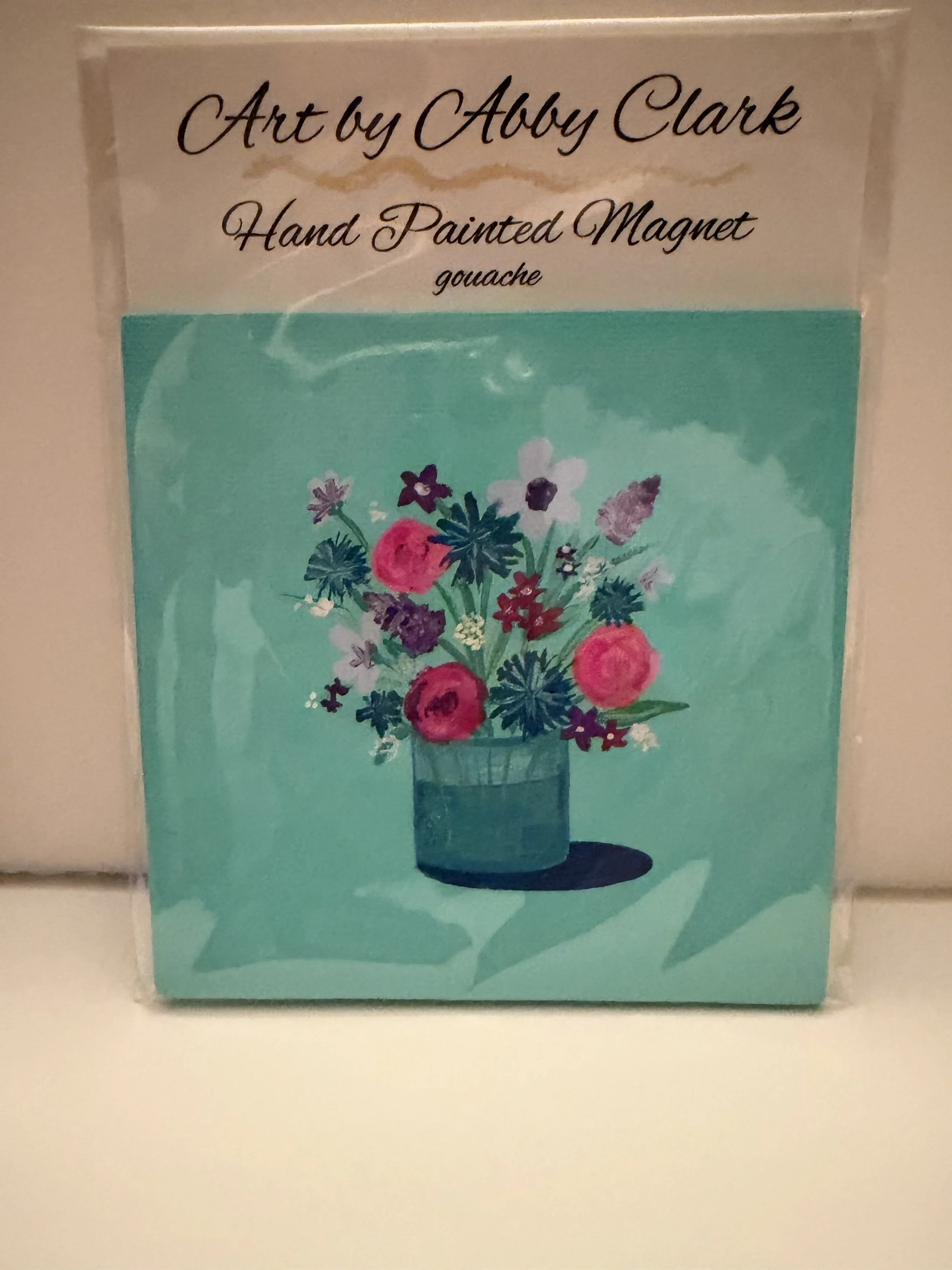 Packaged Floral Bouquet magnet with pink, purple, and white flowers in a teal vase on turquoise