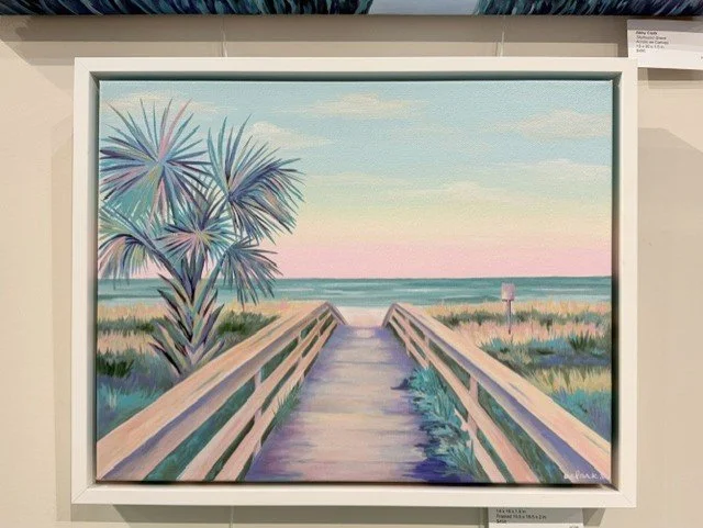 Palmetto Passage in a white frame, showing a boardwalk through dunes toward the ocean beside a palmetto