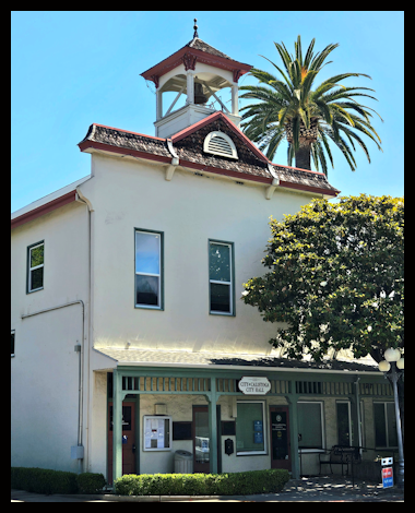 Historic building with a small tower and a sticker on the wall read Centro Cultural Office.
