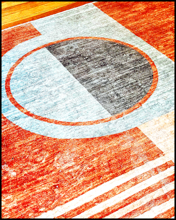 Basketball court with a center circle and court lines, viewed from above.