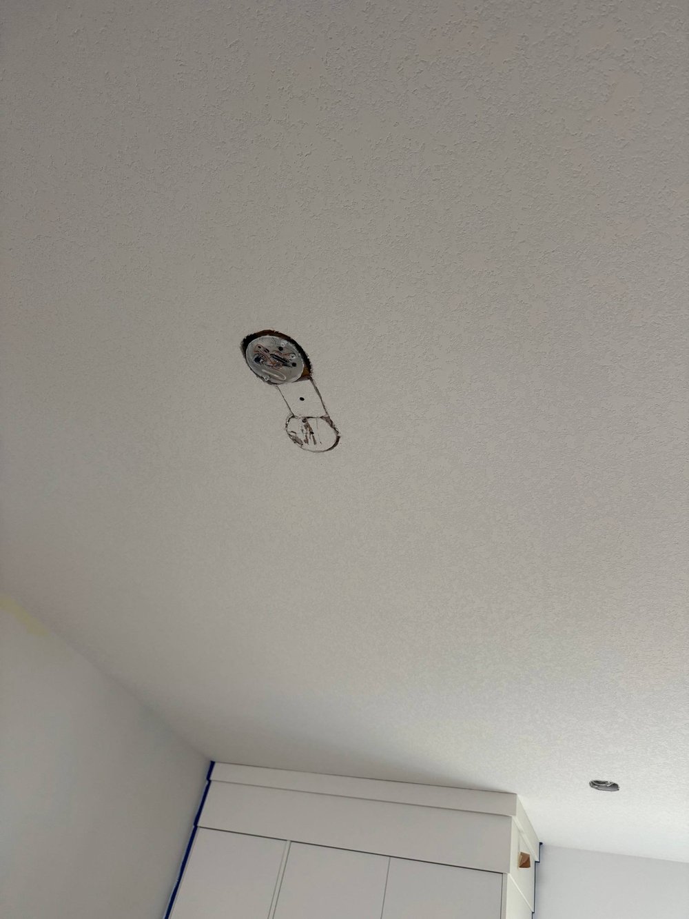 Ceiling light box relocated with drywall patched and textured