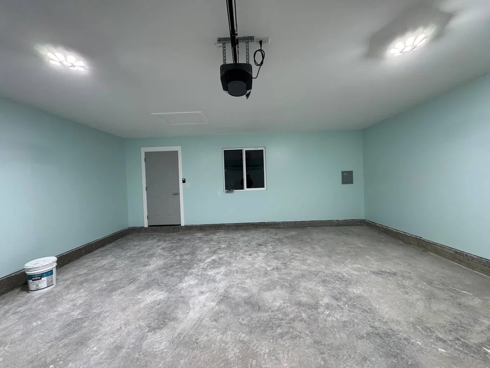 Finished drywall walls and ceiling in a Calgary garage by VM Diamond Construction