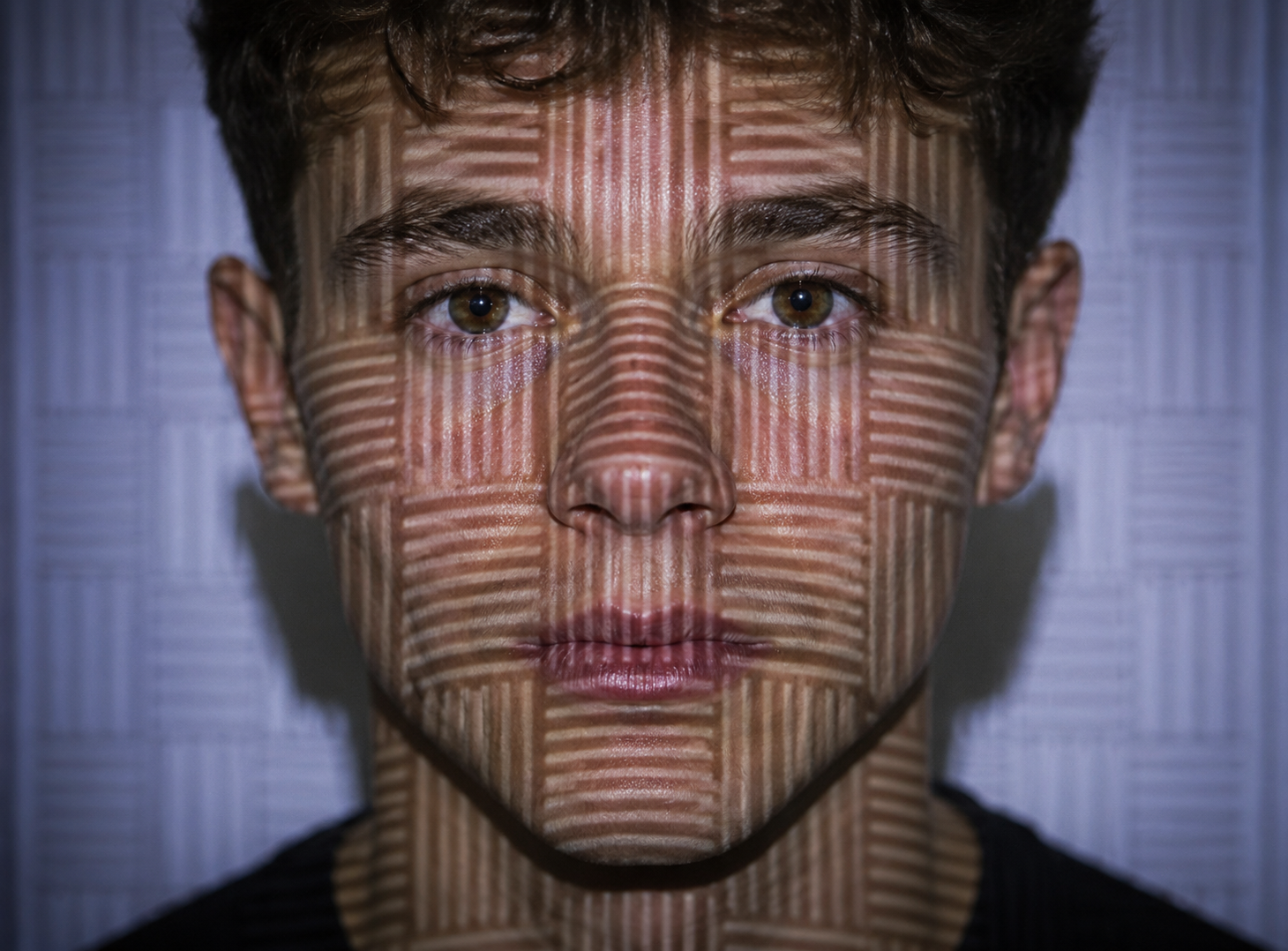A structured light pattern being projected on a face, illustrating how structured light scanners calculate shapes by analyzing the distortion of a light pattern
