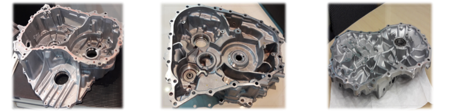Three aluminum engine cases displayed on a surface.