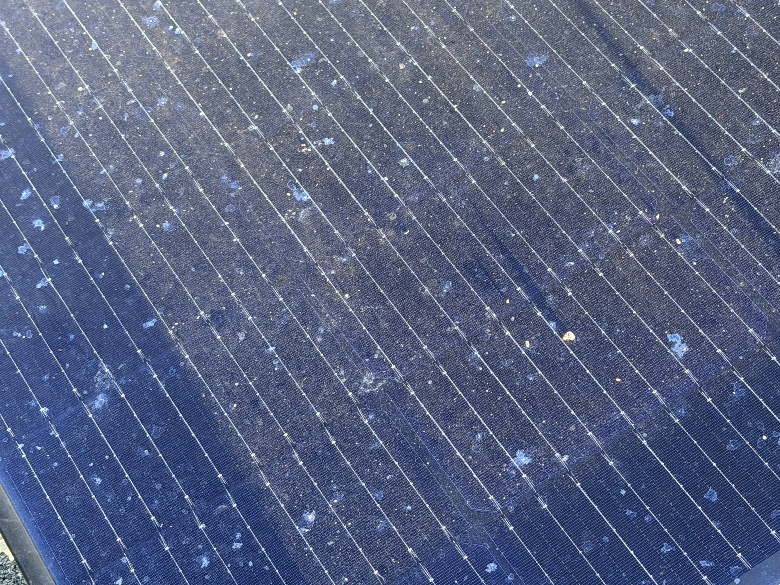 Residential solar panels showing surface buildup before professional cleaning