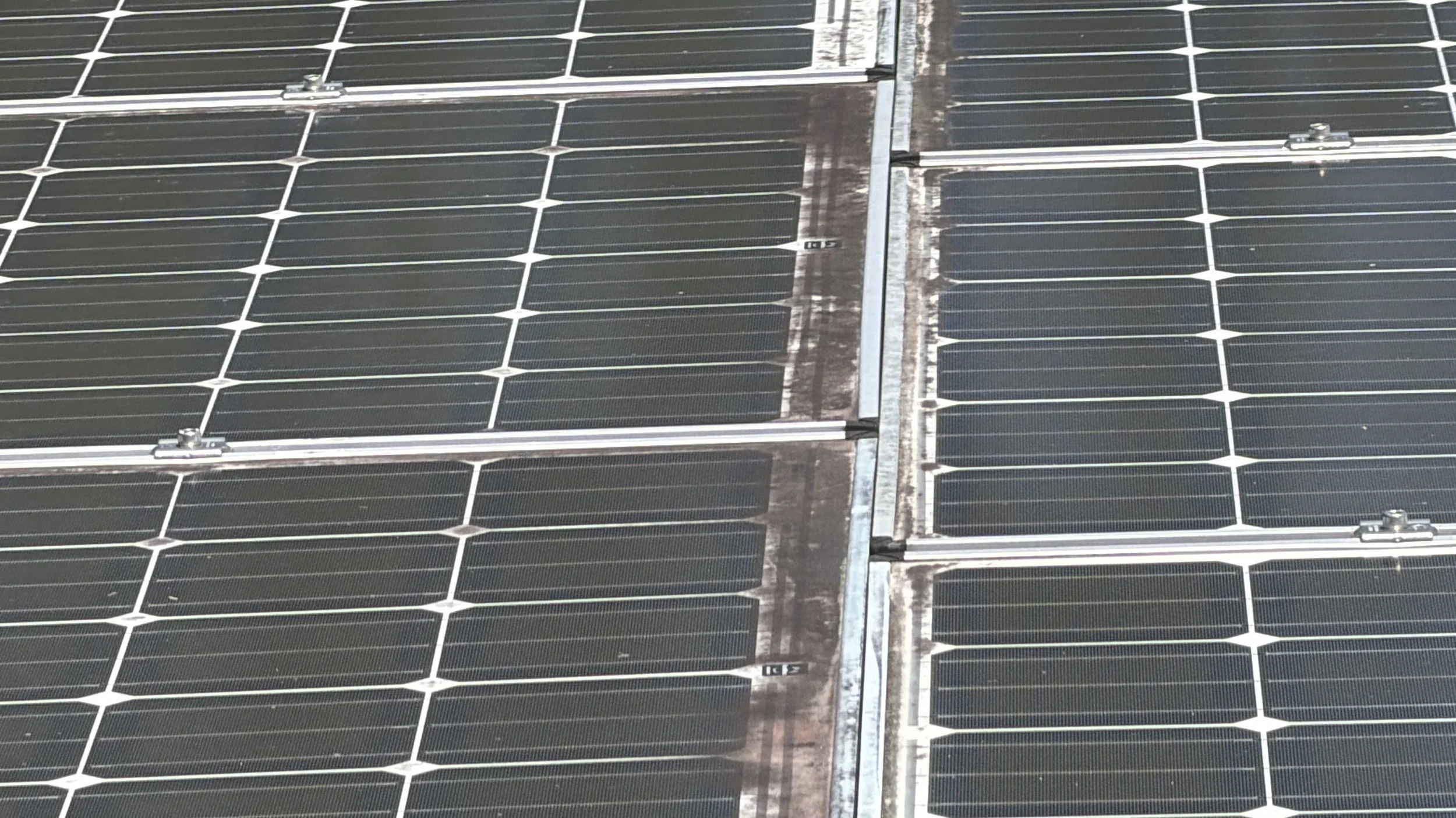 Dirty solar panels with visible dirt and buildup before professional cleaning