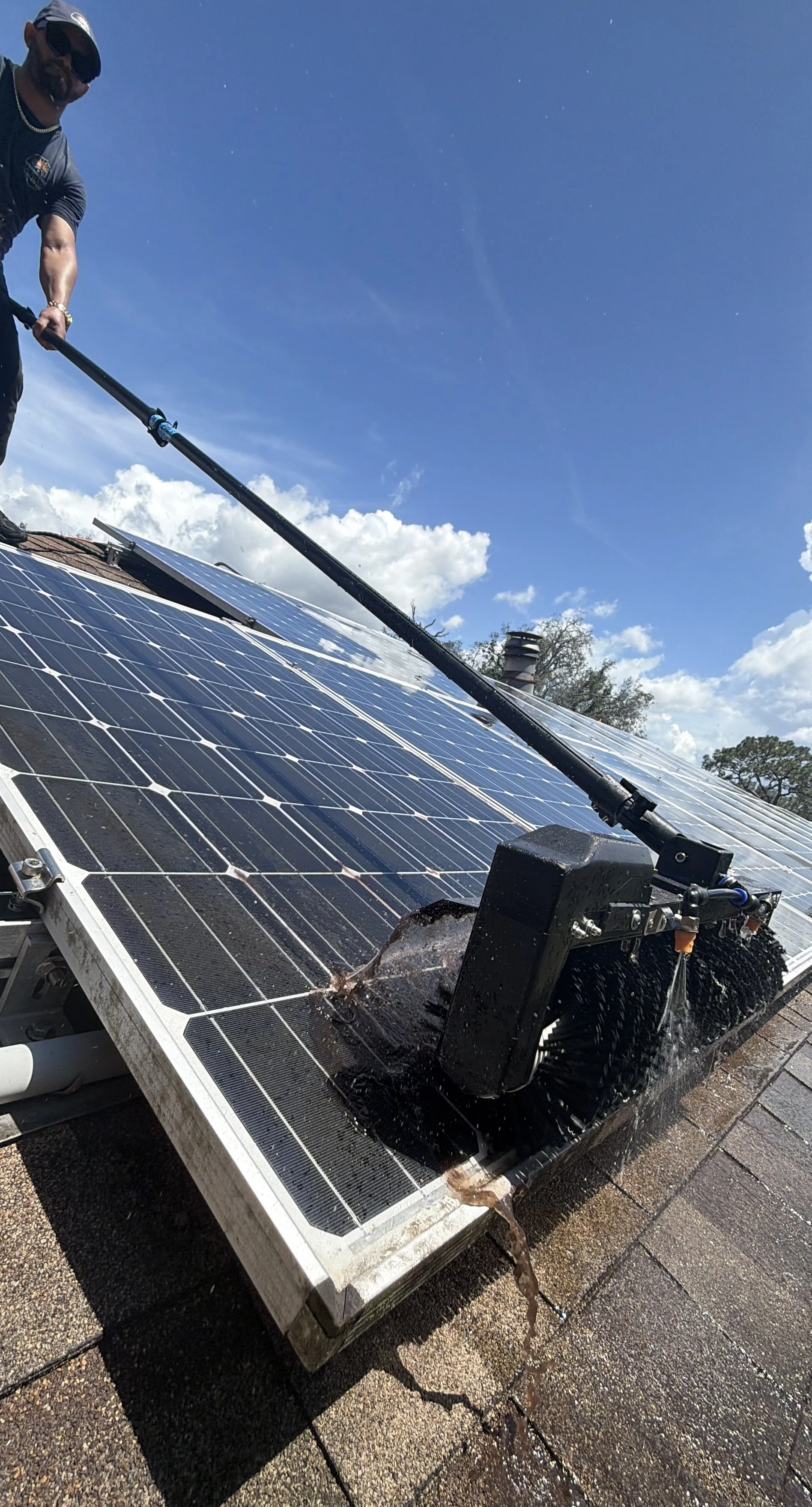 Professional solar panel cleaning with rotary brush removing dirt and buildup