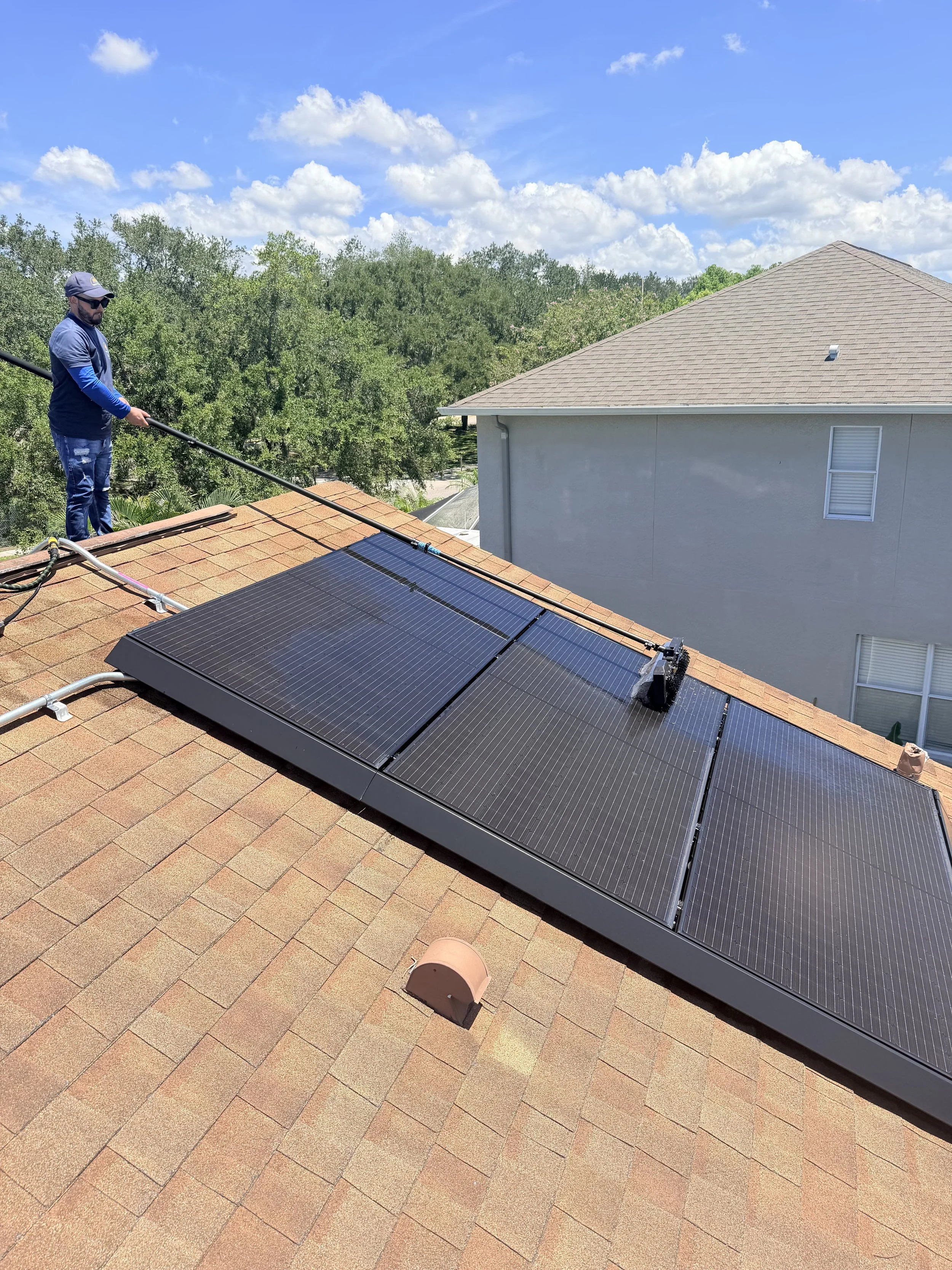 Dirty water and buildup being removed during professional solar panel cleaning