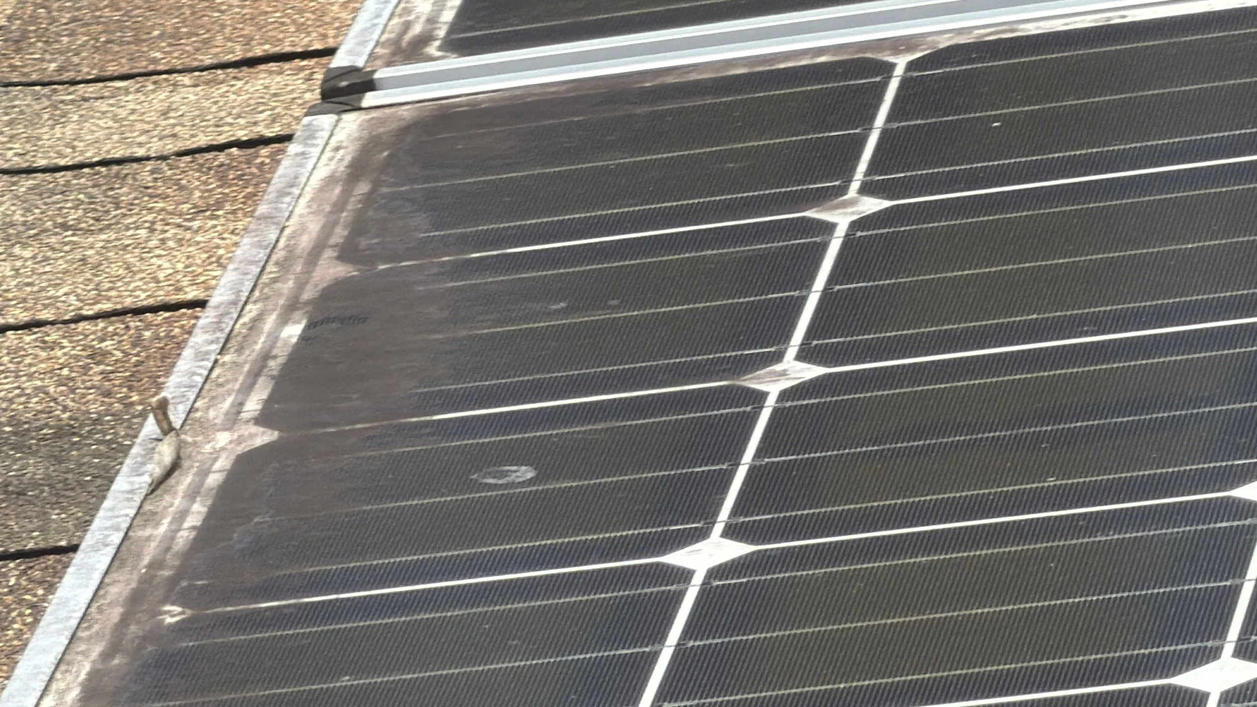 Dirt and debris buildup visible on residential solar panels