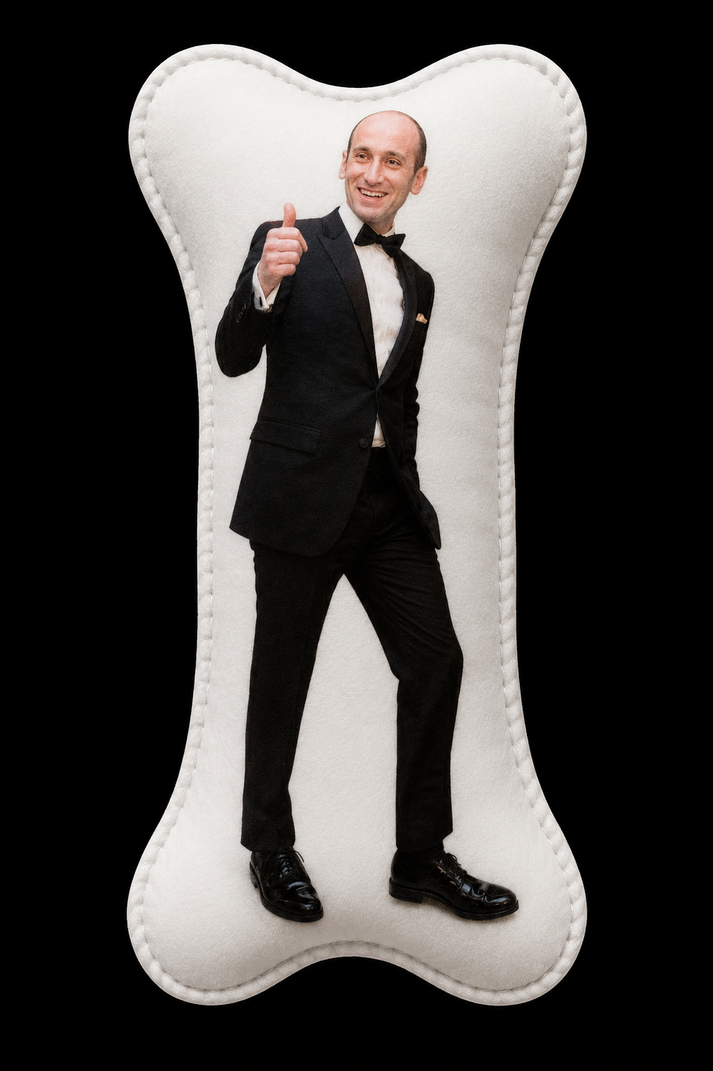 Steven Miller in a tuxedo giving a thumbs-up, standing inside a cut-out shaped like a bone against a black background.