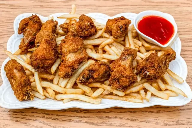 Golden grilled chicken wings seasoned with herbs and butter served with rice or fries
