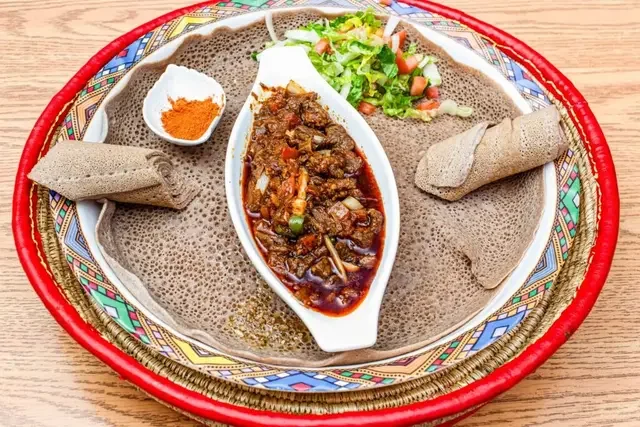 Traditional foul sada with fava beans, vegetables, herbs, lemon and bread