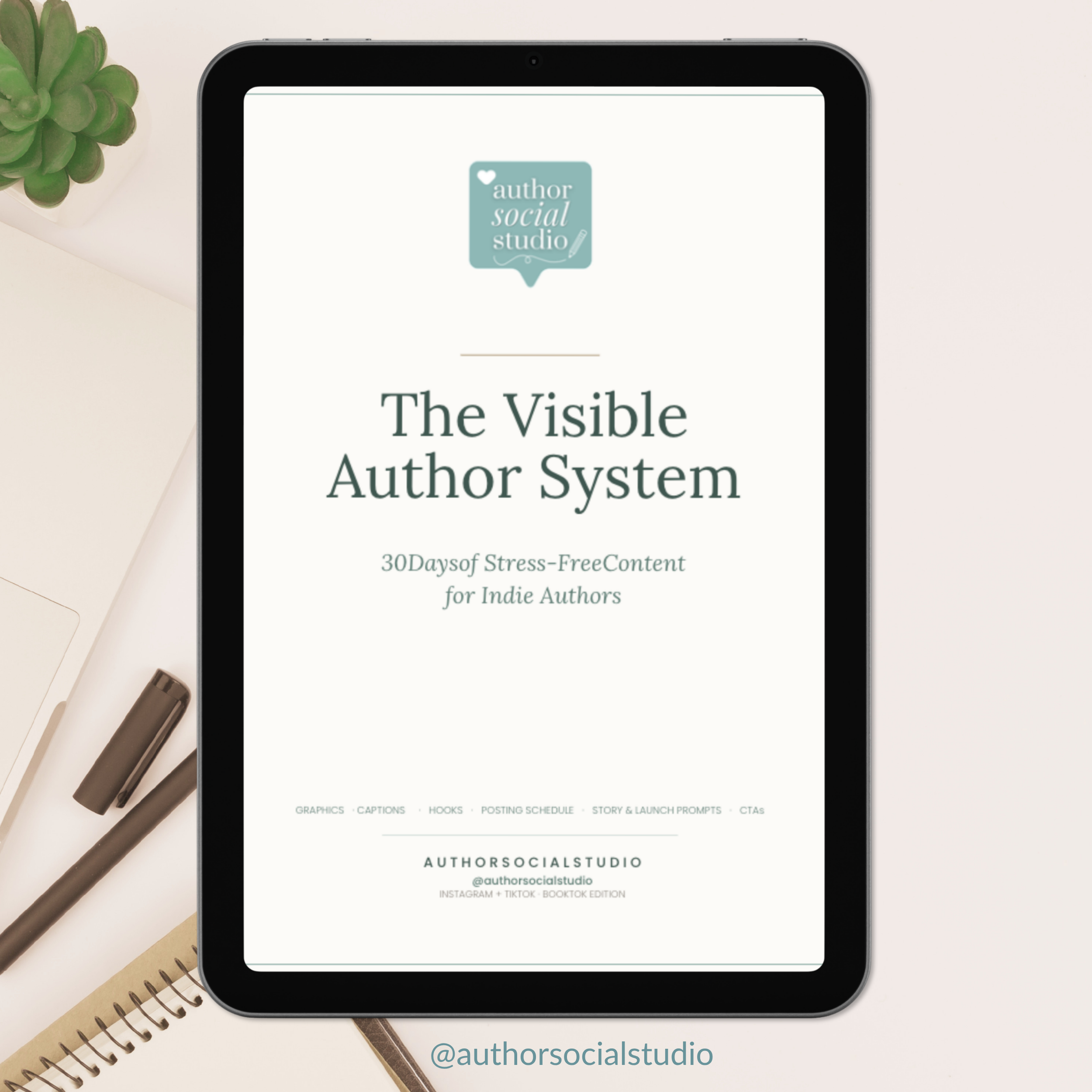 cover of The Visible Author System guide on an iPad, positioned on a white desk.