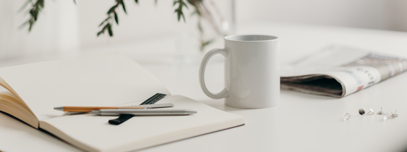 indie author book, pens and coffee cup on a white desk