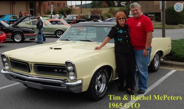 Couple enjoying their old car