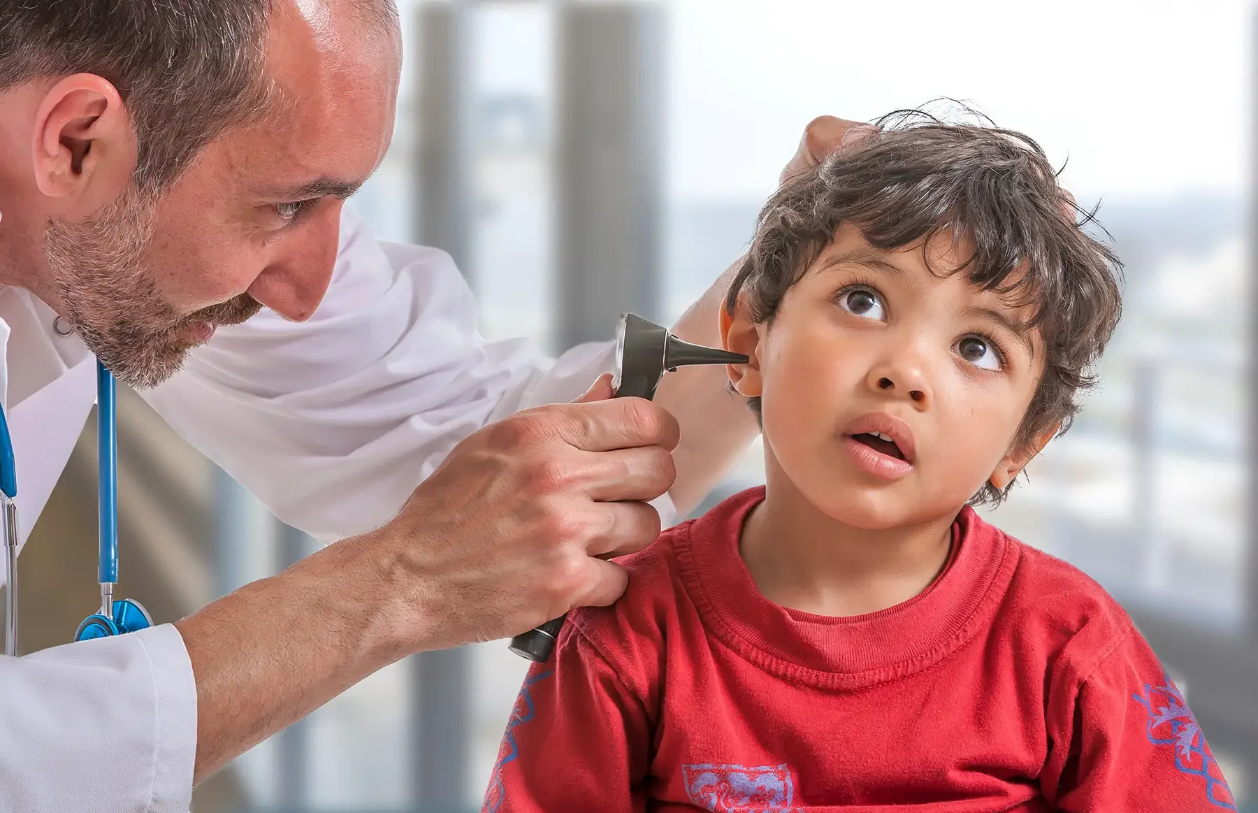 doctor checking a young boys ear