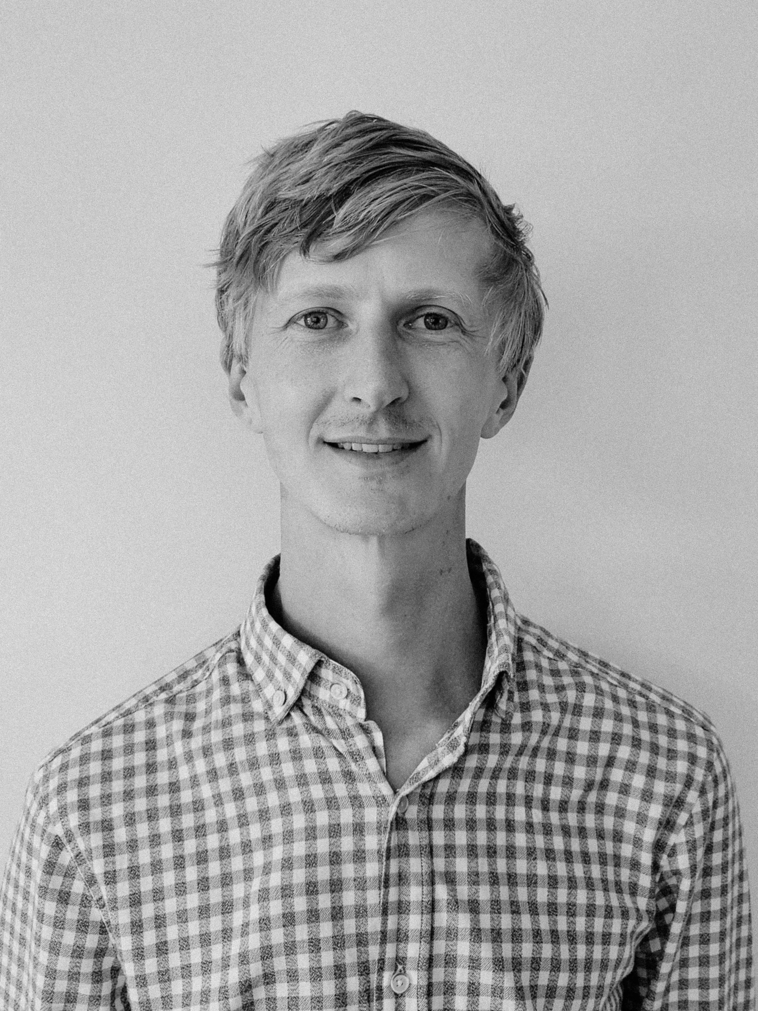 A photo of Patrick, in Black and White, Smiling