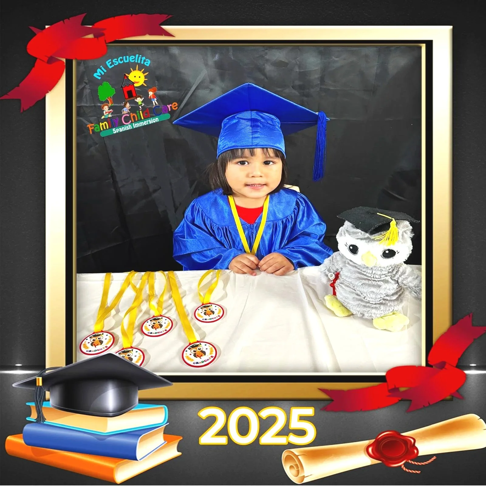 Young girl in a graduation cap and gown sitting at a table with diplomas, graduation medals, and a stuffed owl wearing a mortarboard.