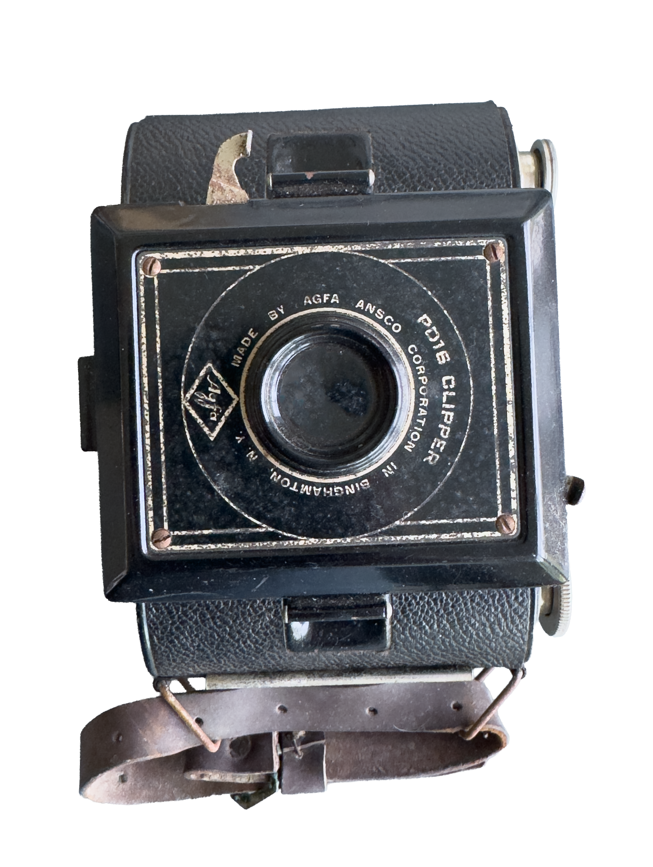 A vintage box camera with a textured black body, a circular lens, and metallic accents, positioned on a table or surface.