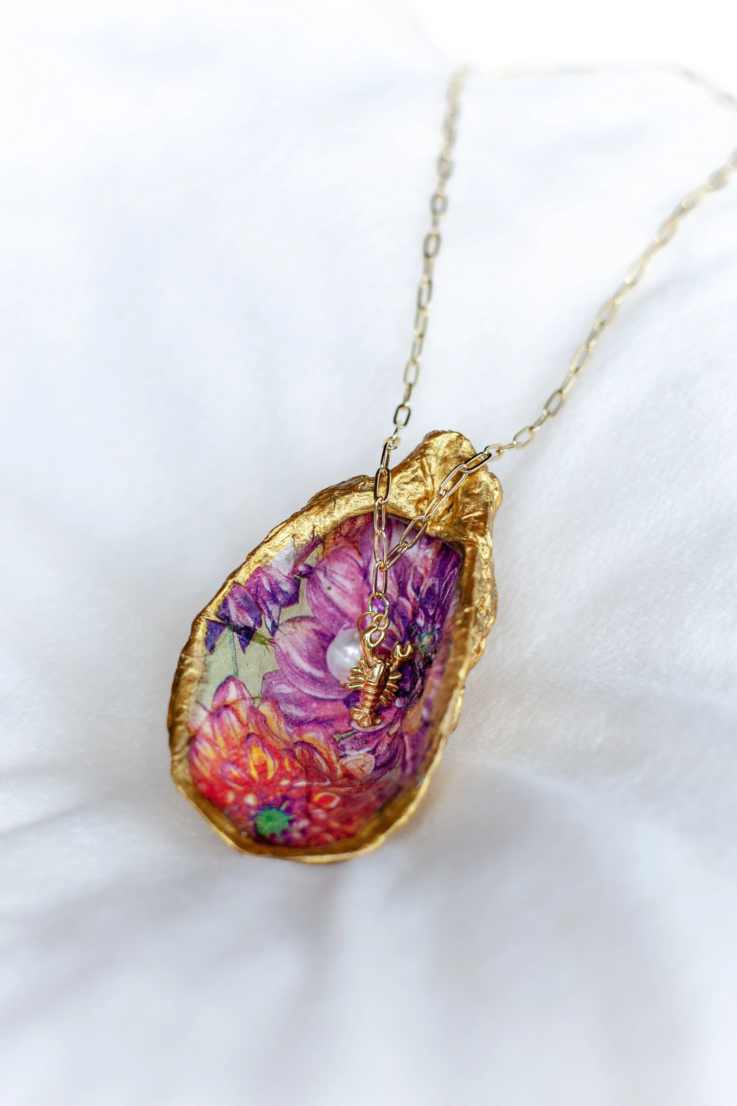 leaf&letter-Lobster and Pearl Toggle necklace on pink oyster.jpg