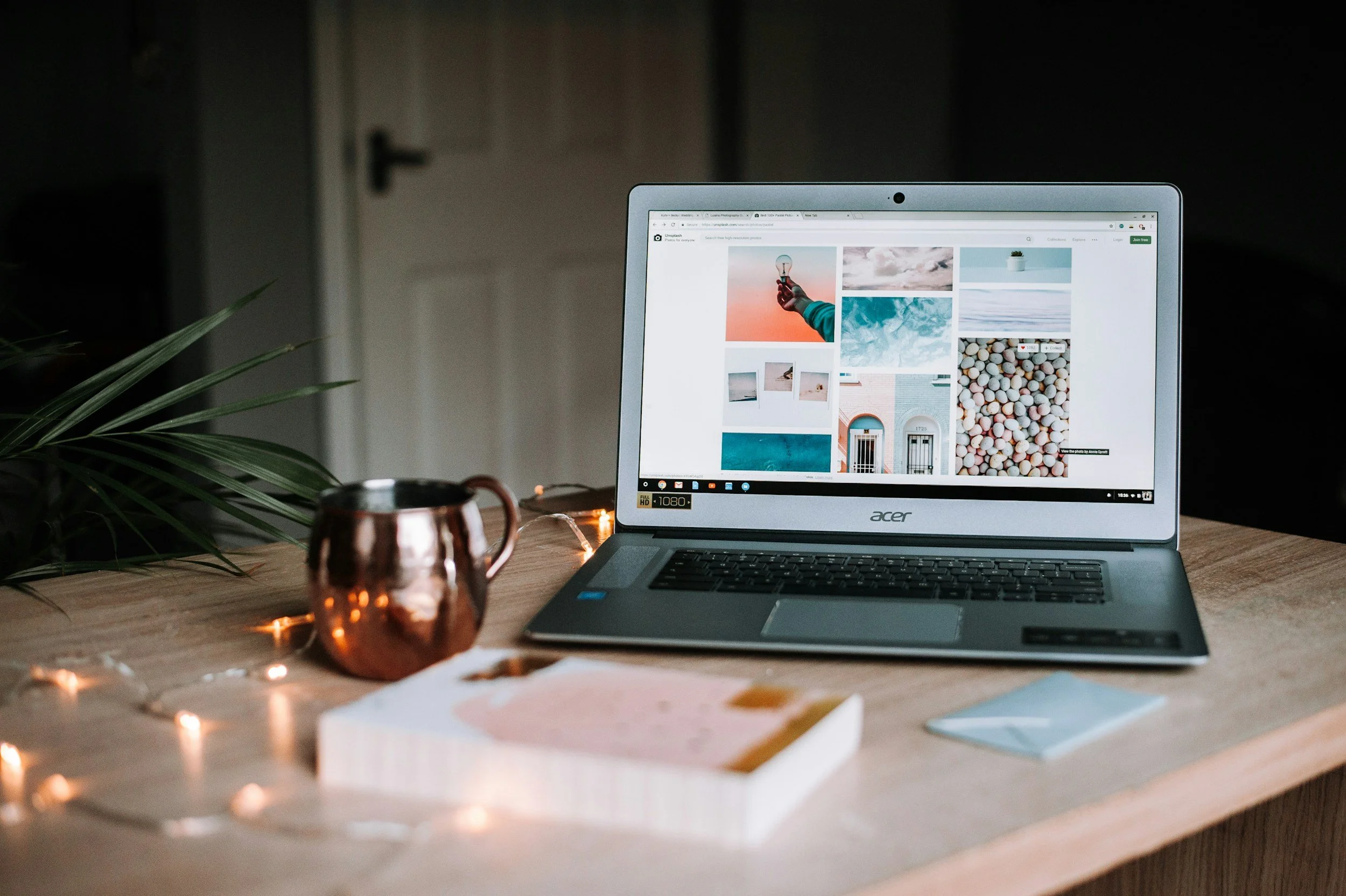 Workspace with laptop displaying website content, branding, and planning.
