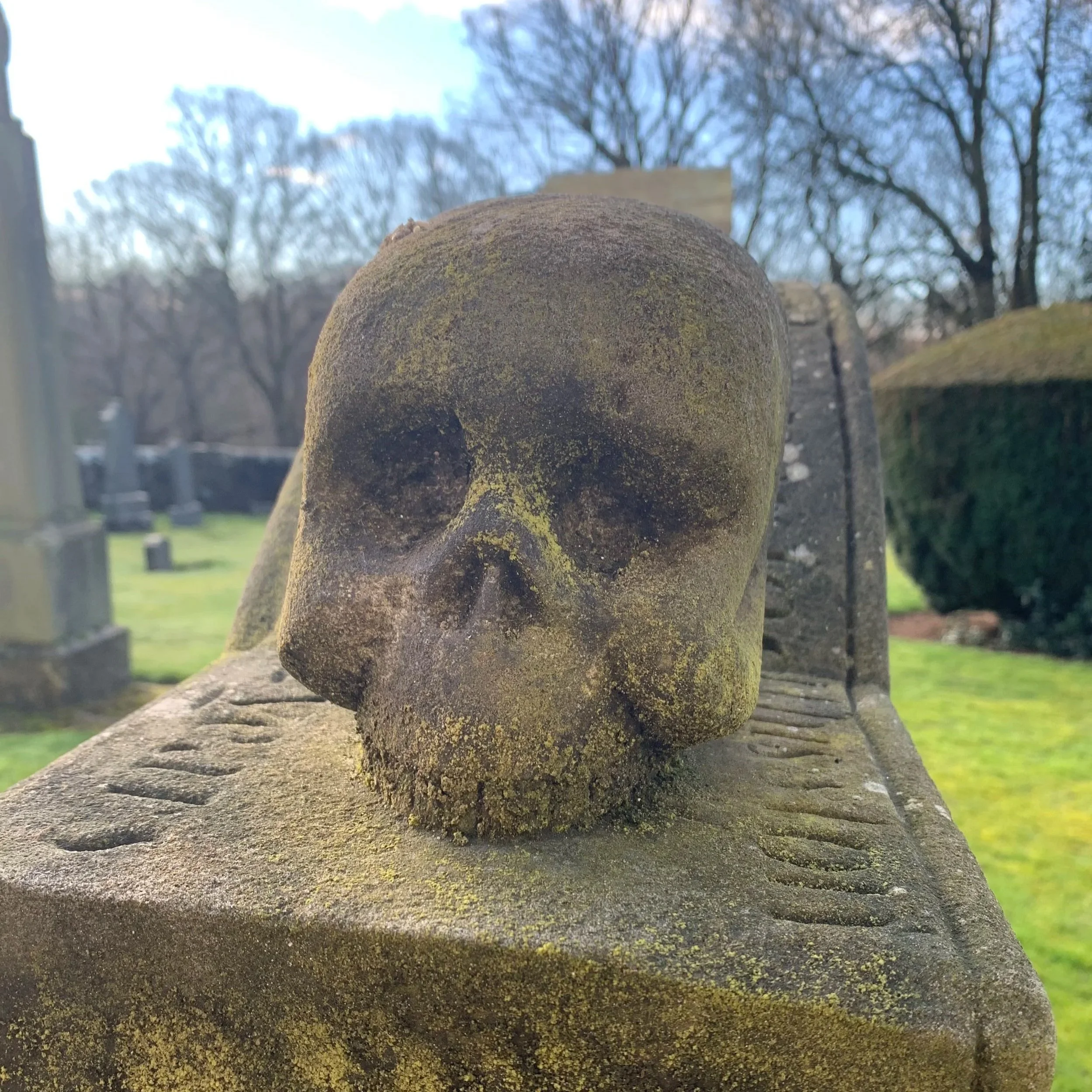 Carved stone skull on top of a gravestone in an old churchyard. Laura Doak historian author and historical consultant New Zealand Scotland England Ireland Wales British Isles propaganda executions riots rebellion Bothwell Bridge podcast guest royal