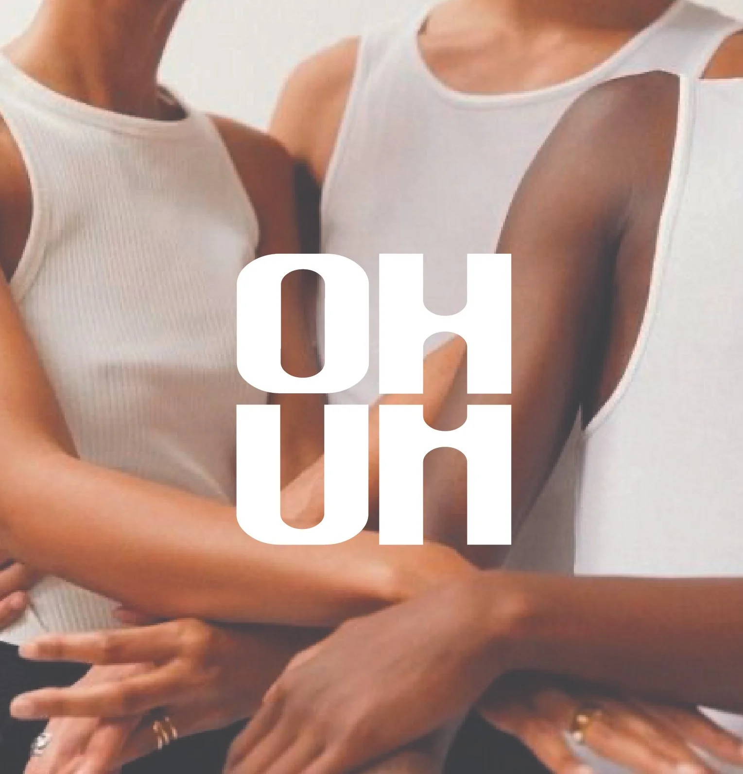 Multiple arms of different people entwined, with one person's arm extending upward and the word 'OHUM' overlayed in large white text.