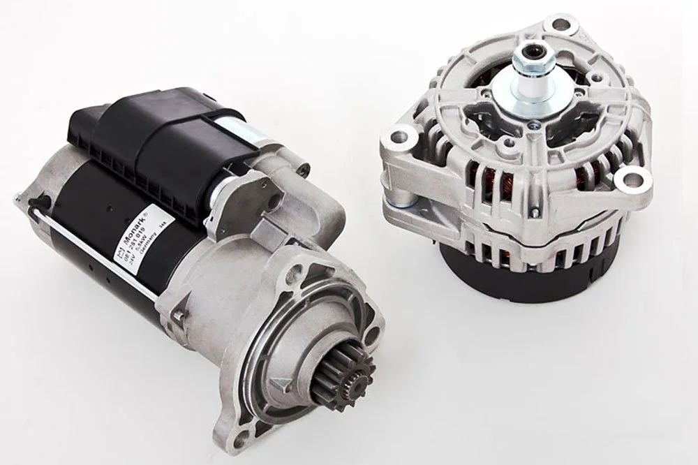 Automotive starter motor and alternator on a white background.