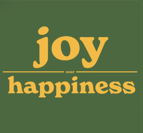 Green background with the words "joy over happiness" in yellow text, with "over" in smaller letters between two lines.