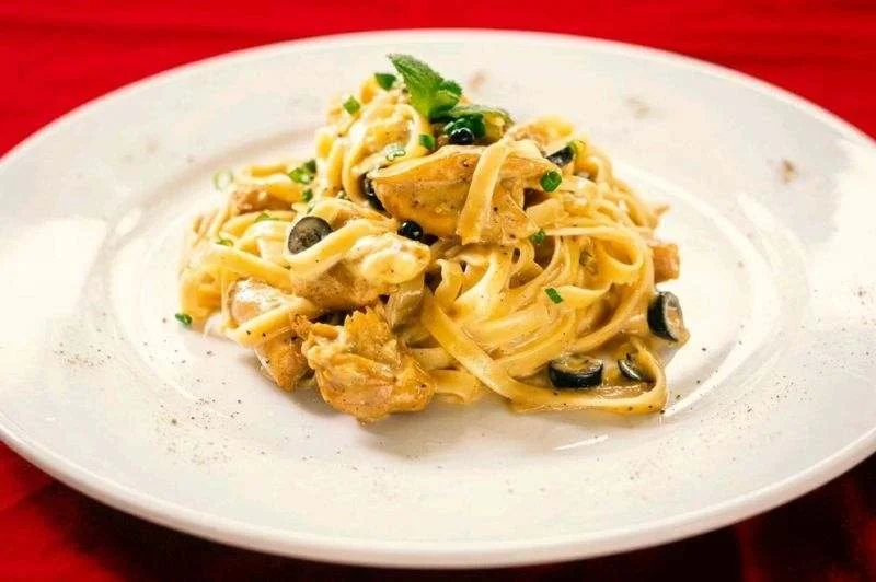 Creamy pasta with chicken, olives, and herbs.