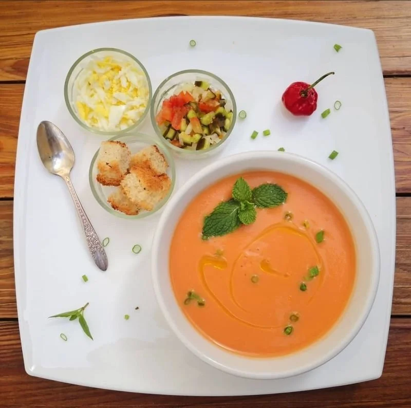 Orange soup with mint and fresh accompaniments.