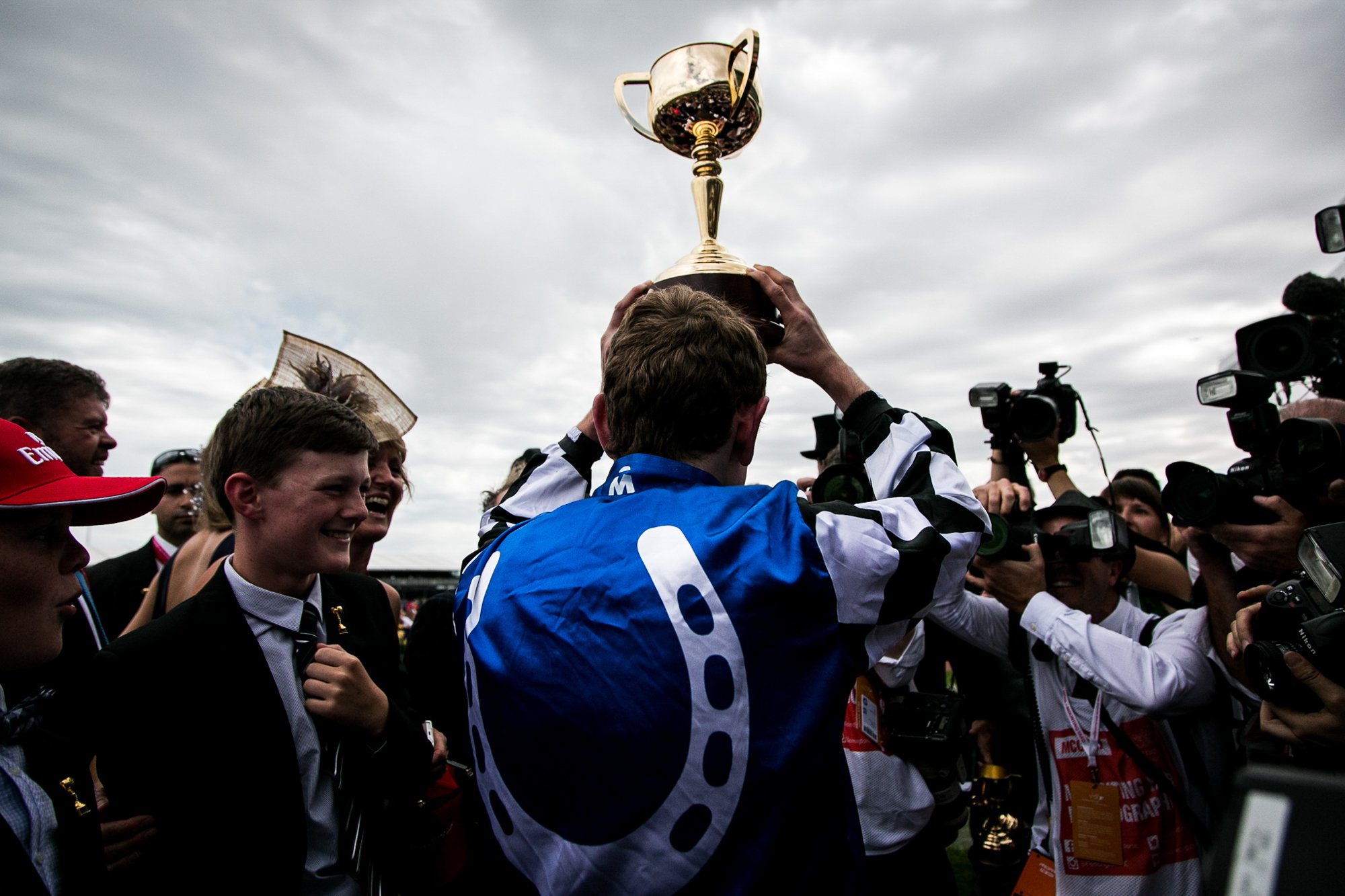 Melbourne Cup winning jockey Ryan Moore raises the trophy after riding Protectionist.