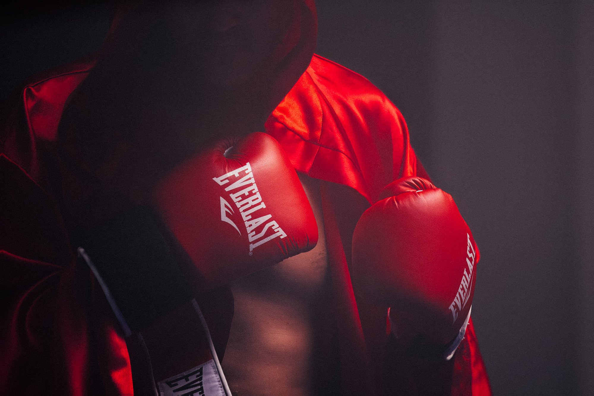 A boxer wearing everlast boxing gloves and cape poses during a campaign photoshoot for Everlast