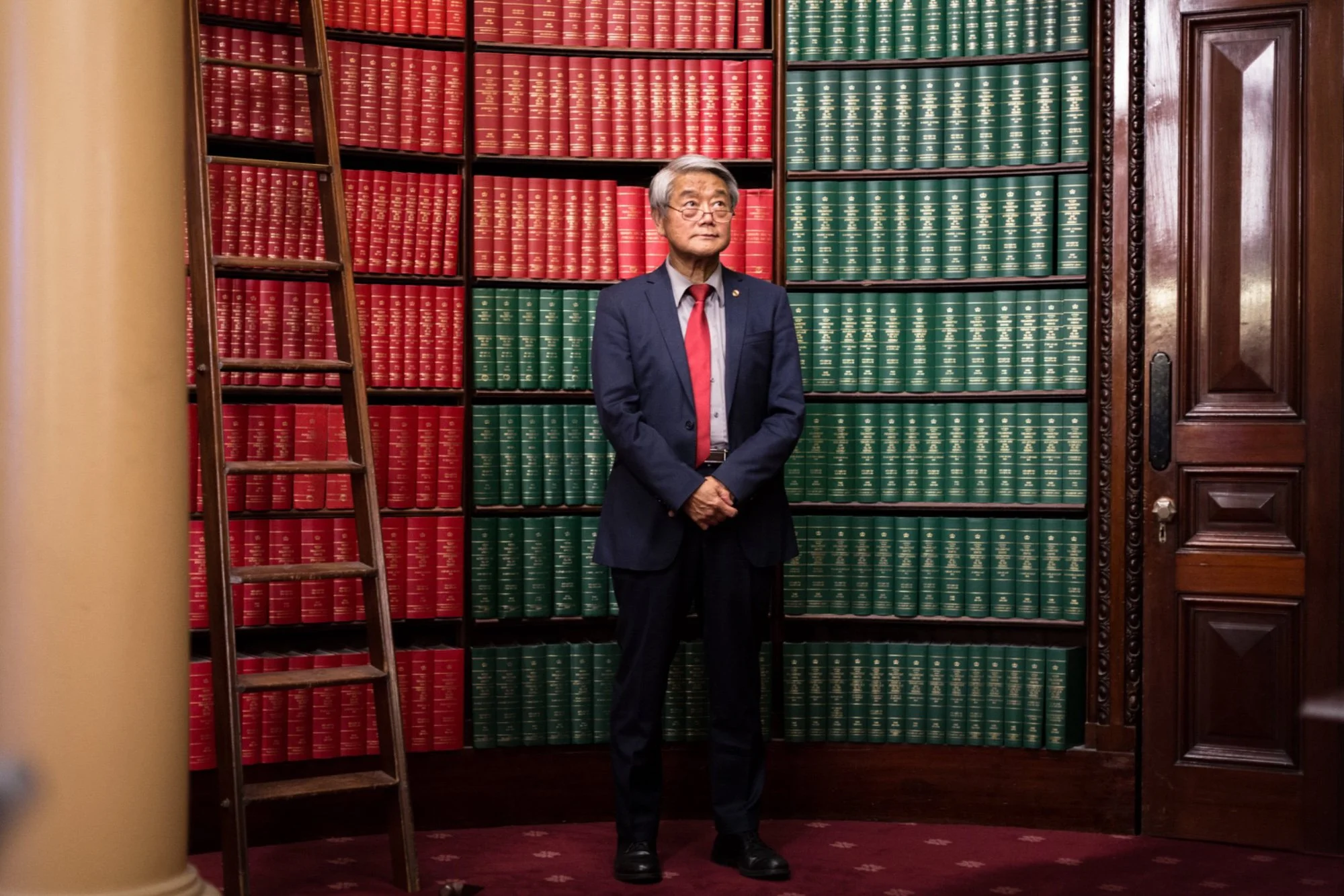 A portrait of Hong Lim MP in the library at the Victorian Parliament House